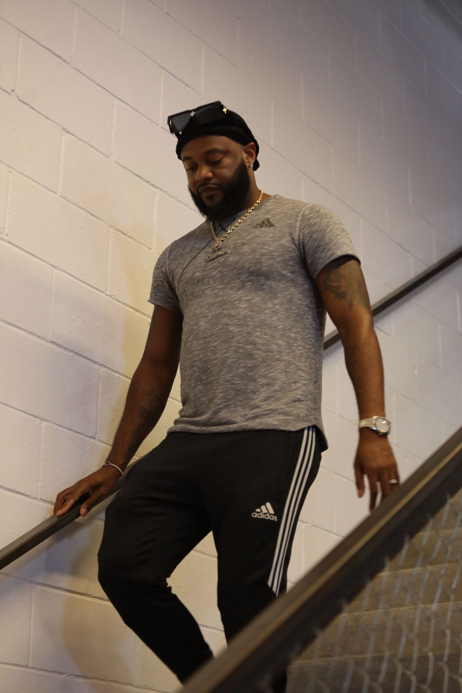 Person in gray t-shirt and black pants descending stairs in sequence of action shots.