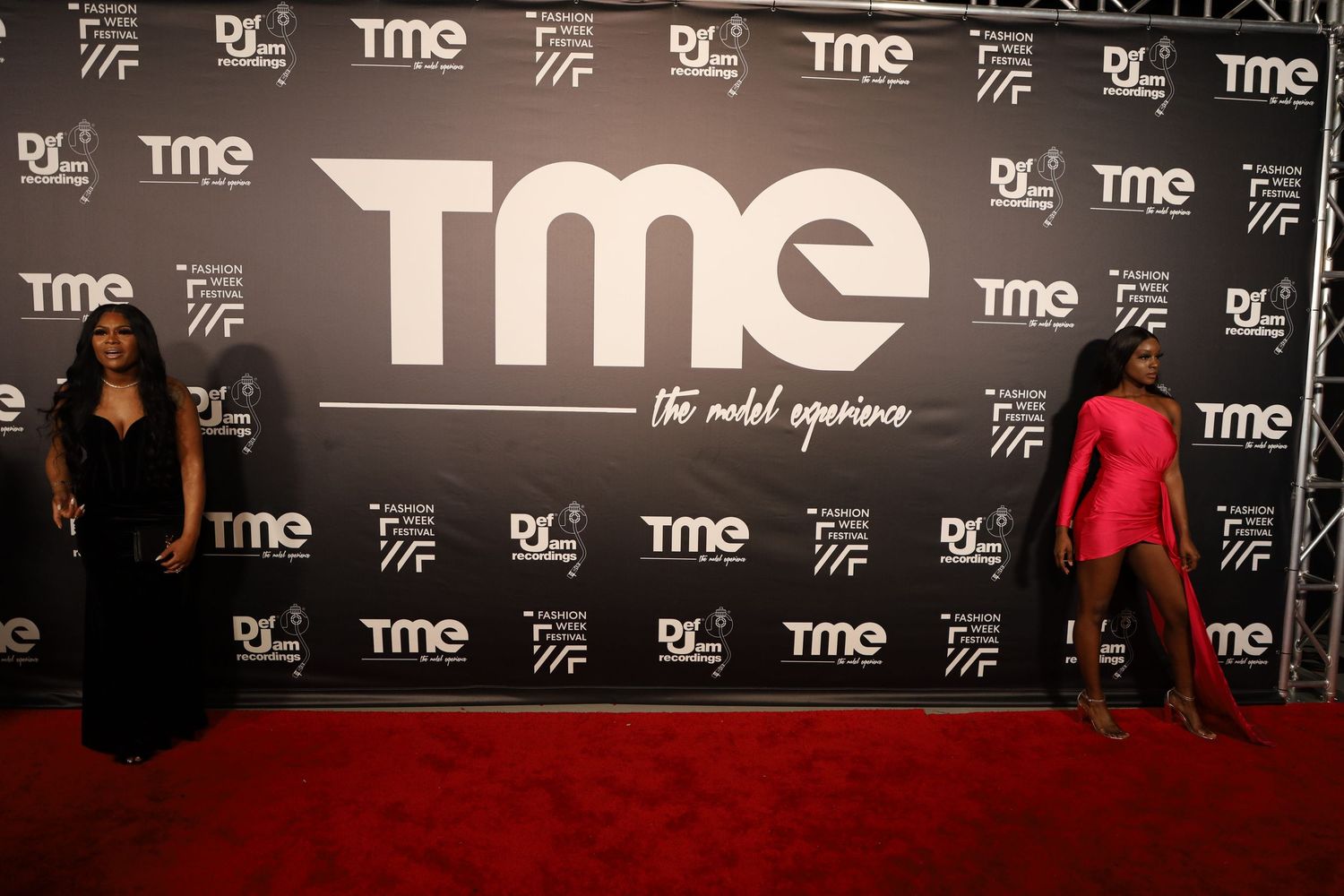Red carpet scene at TME fashion event with branded backdrop wall.