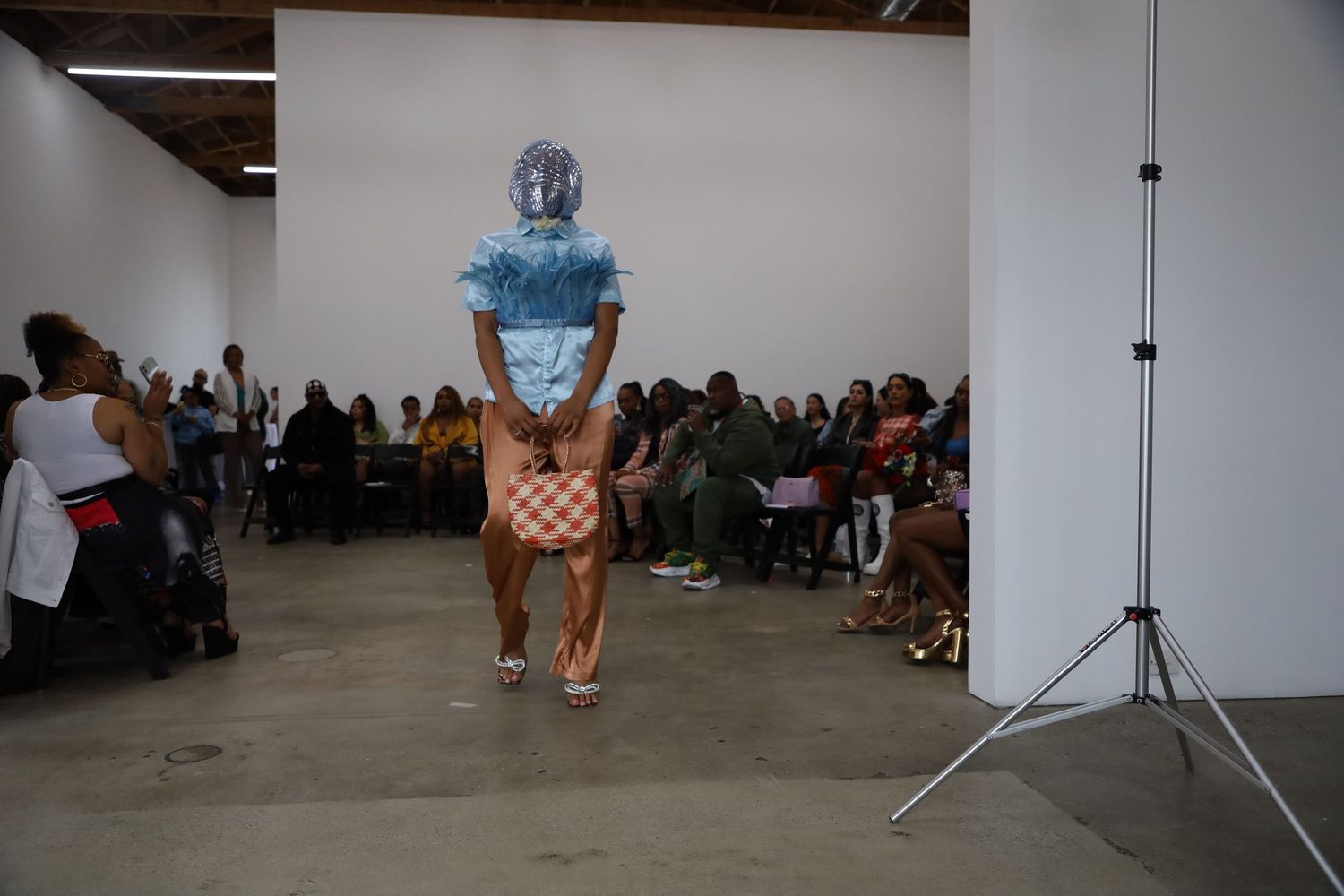 Gallery runway show highlights retro-inspired blue and peach ensemble.
