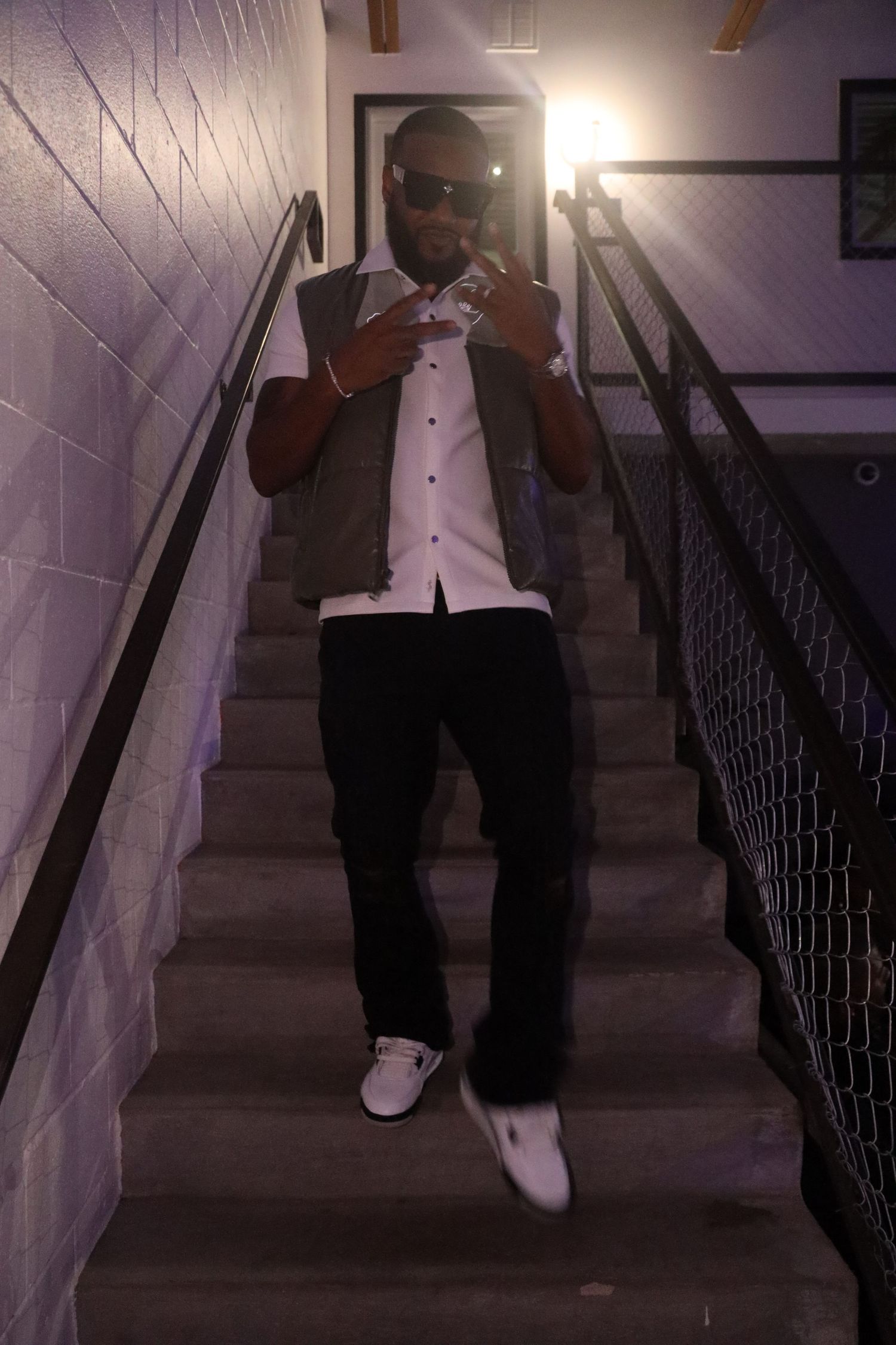 Black and white formal wear ensemble photographed descending staircase.