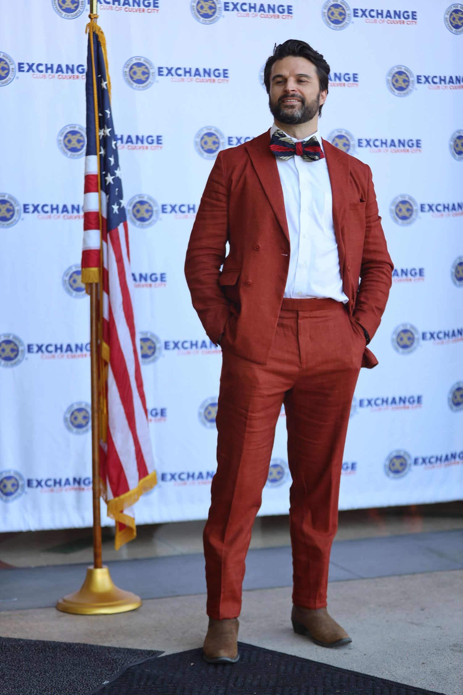 Person models burgundy suit at Exchange branded photo opportunity.