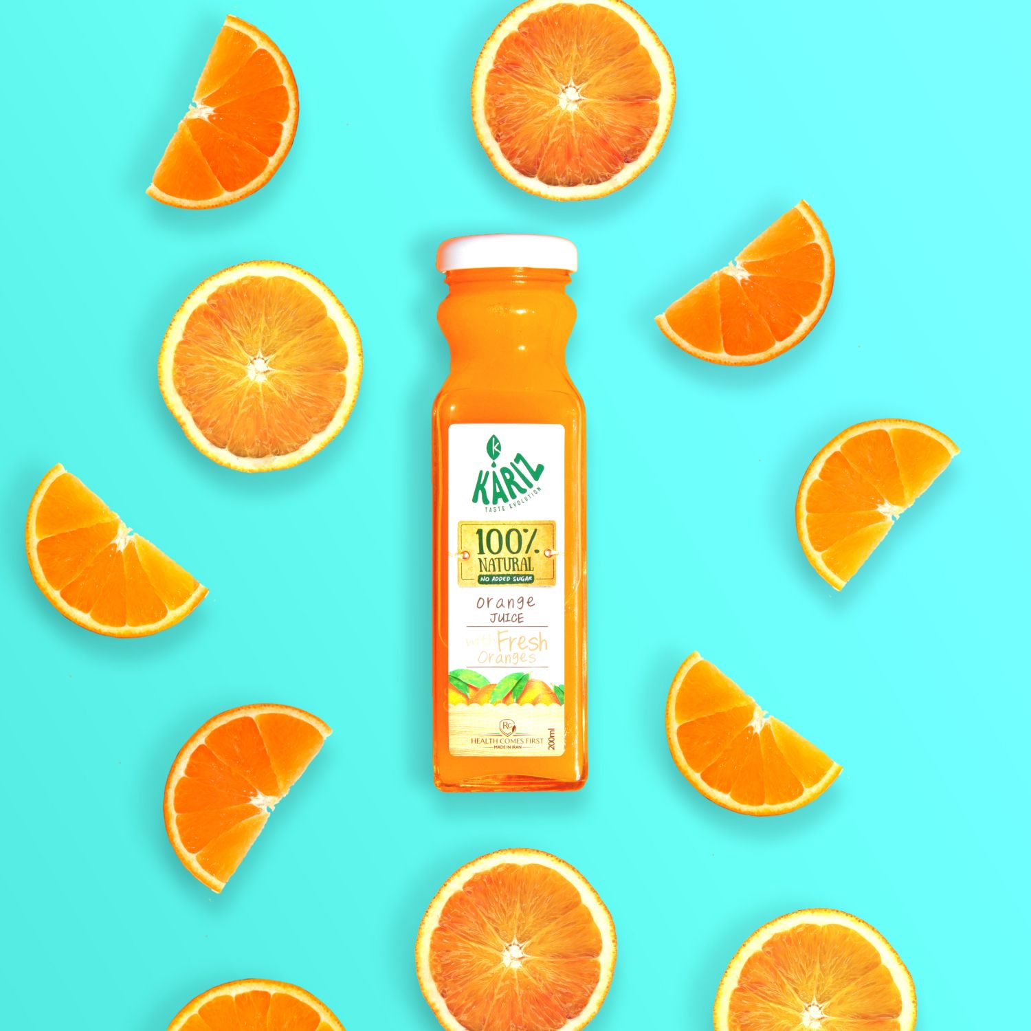 A bottle of 100% natural orange juice surrounded by fresh orange slices on a bright turquoise background.