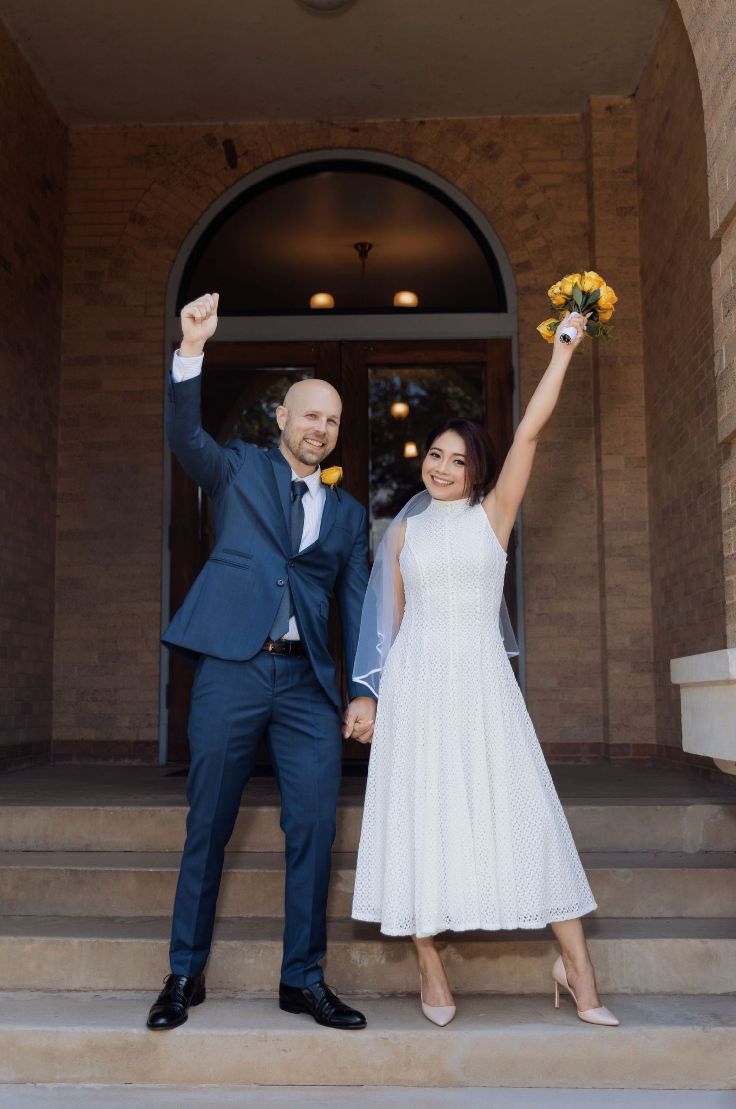 Fun sequence of newlyweds dancing and celebrating in an arched stone hallway.