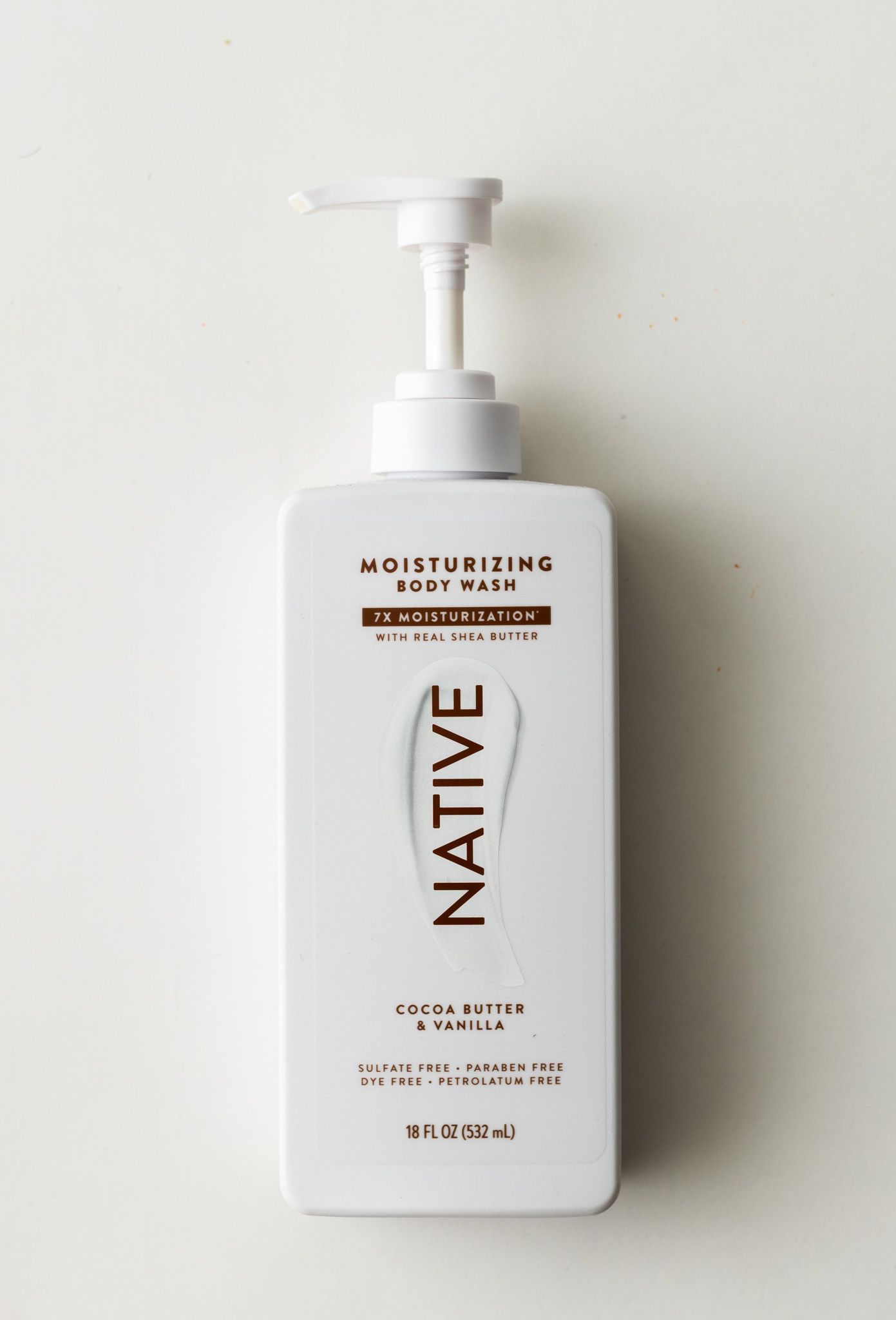 Native moisturizing body wash with cocoa butter and vanilla in a white pump bottle, 18 fl oz.
