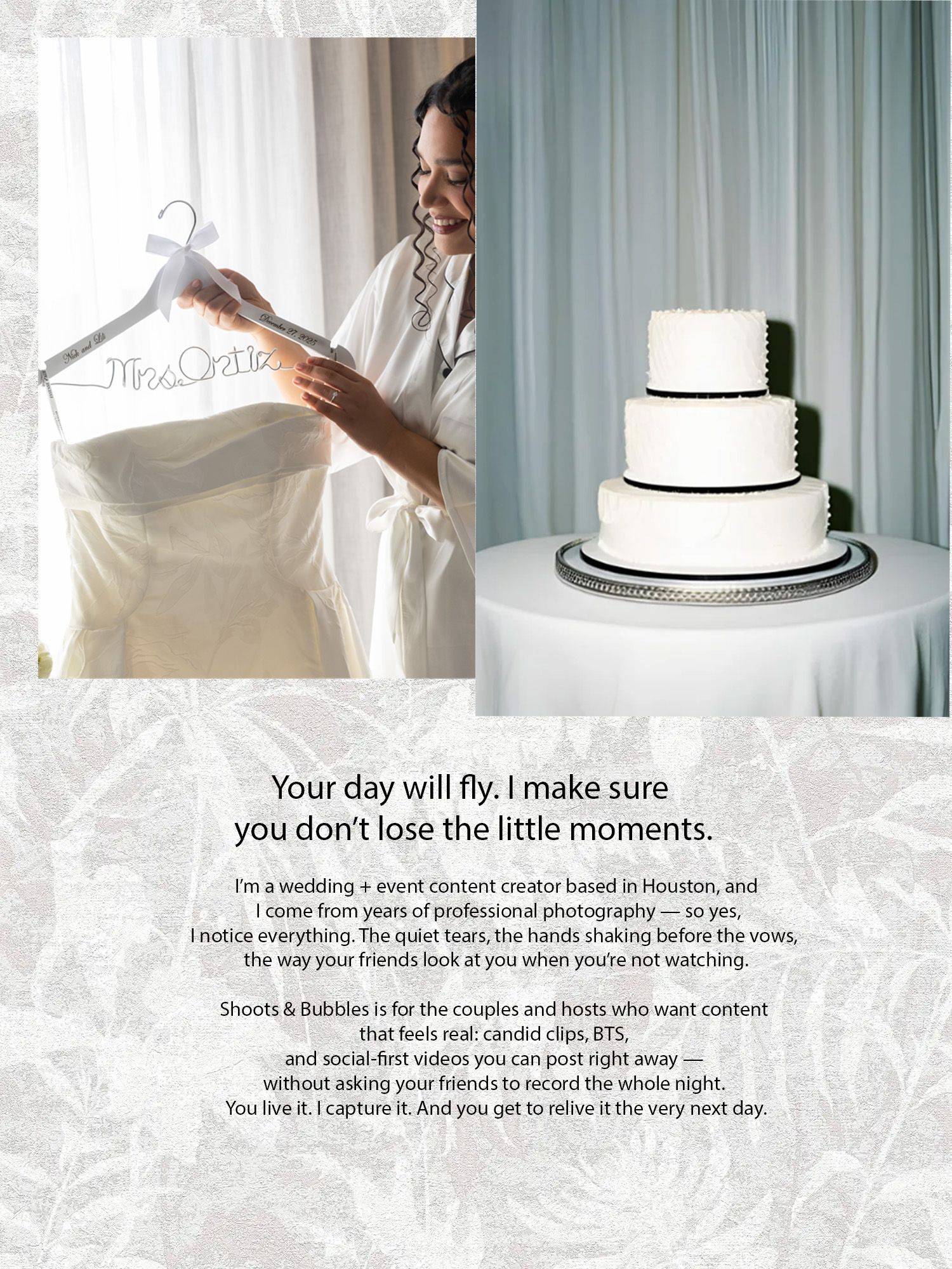 A wedding dress hangs on a personalized hanger next to an elegant three-tiered white cake with black ribbon trim.