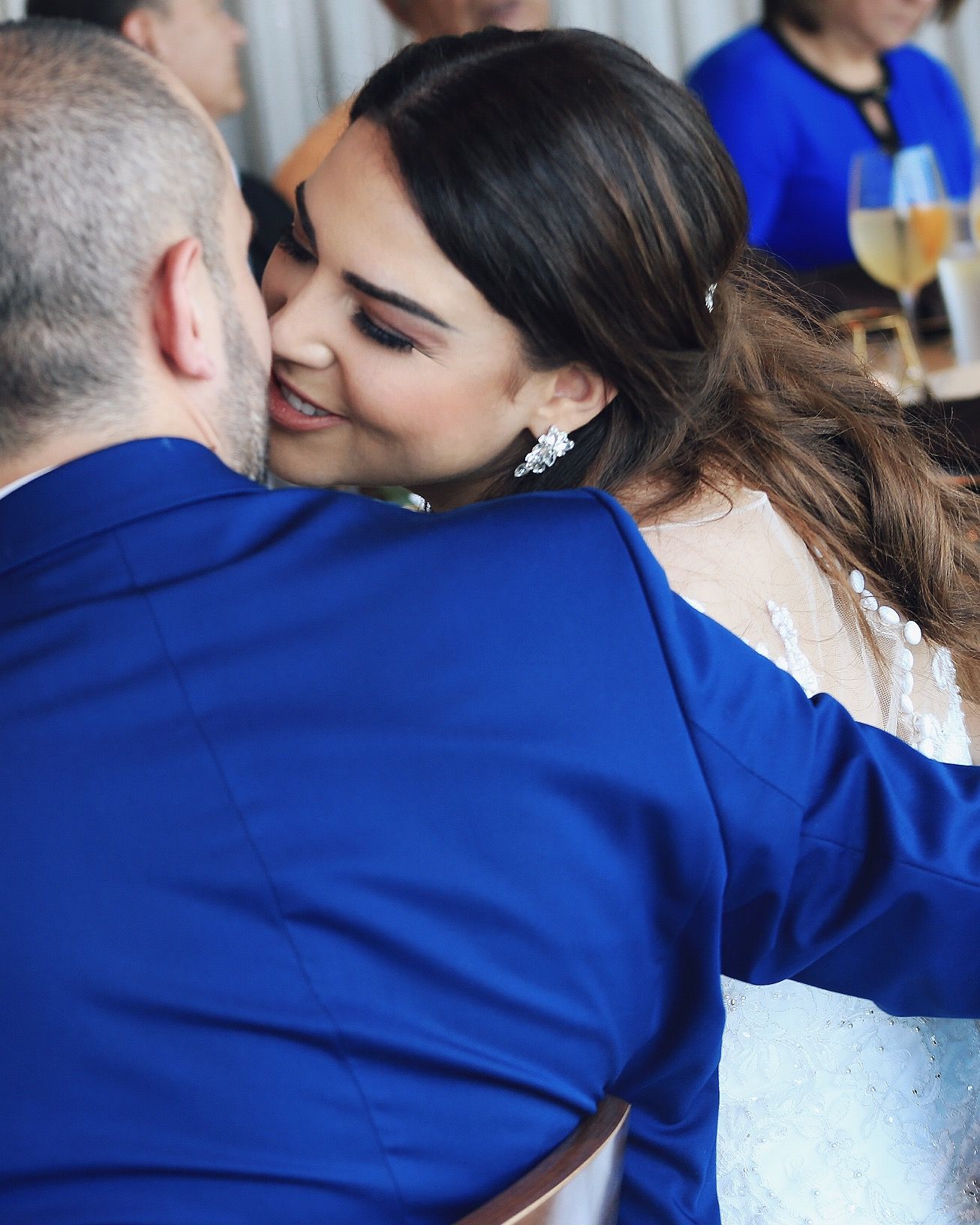 A sequence of five photos showing two people in blue embracing in an affectionate moment.