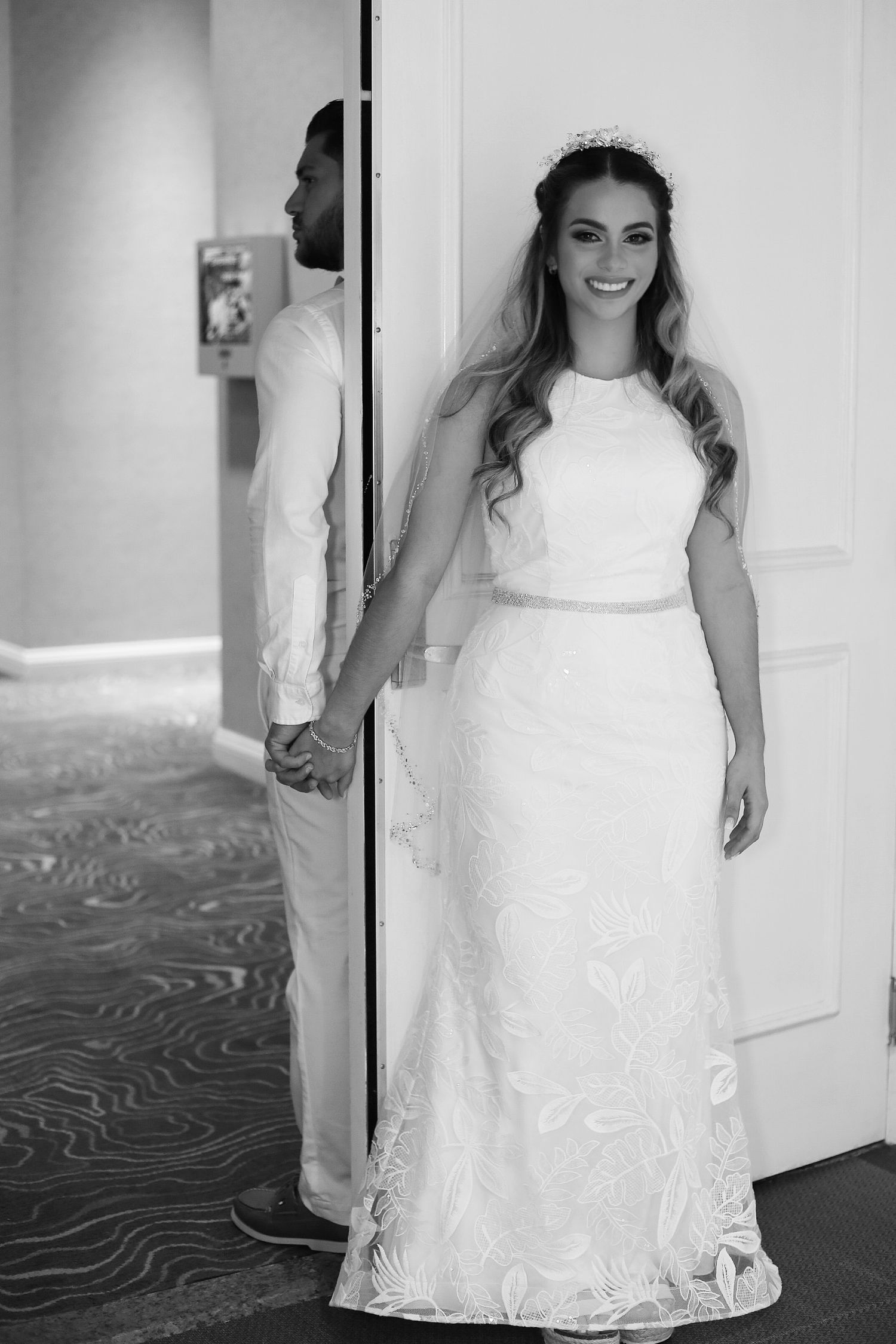 Black and white photo series showing a bride in a white lace wedding dress posing in different angles.