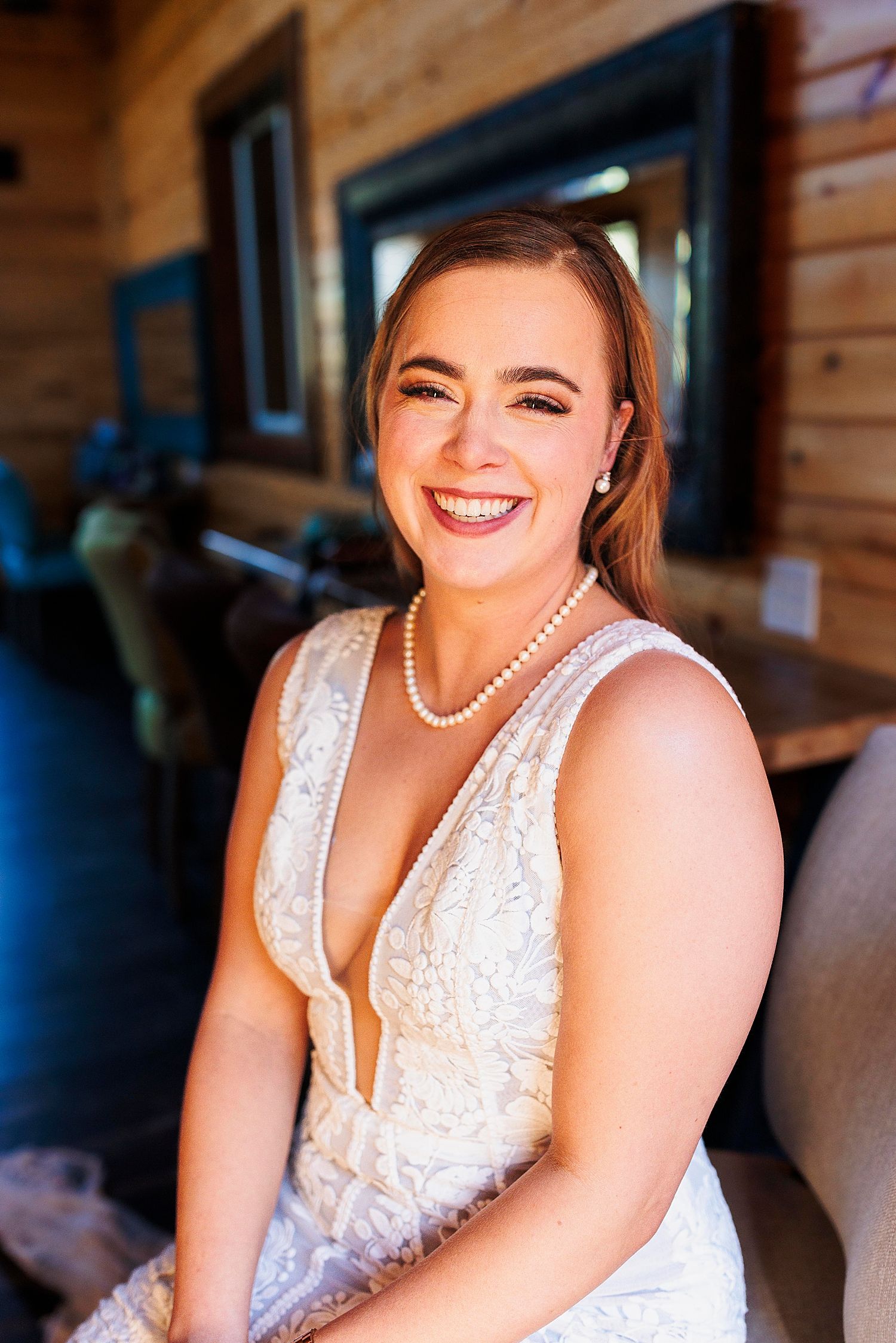 woman in lace bridal gown grins before the ceremony in the Texas Hill Country