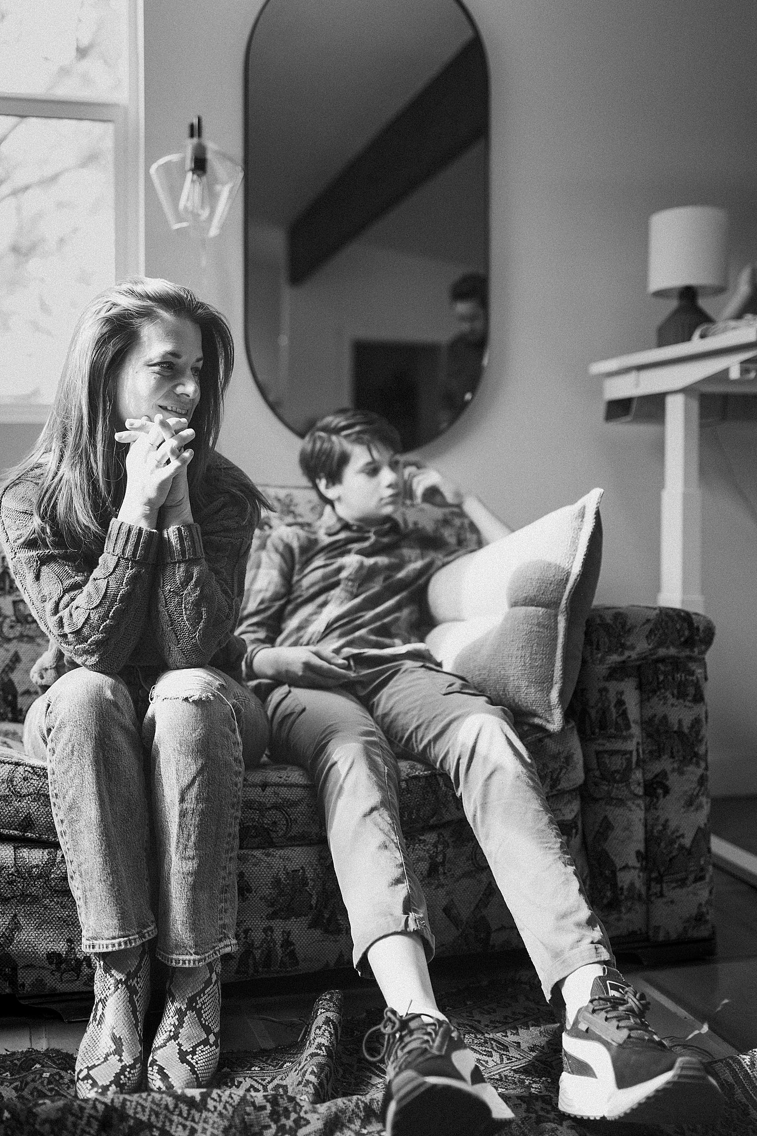 mom and son watch the dogs play in studio by Austin family photographer