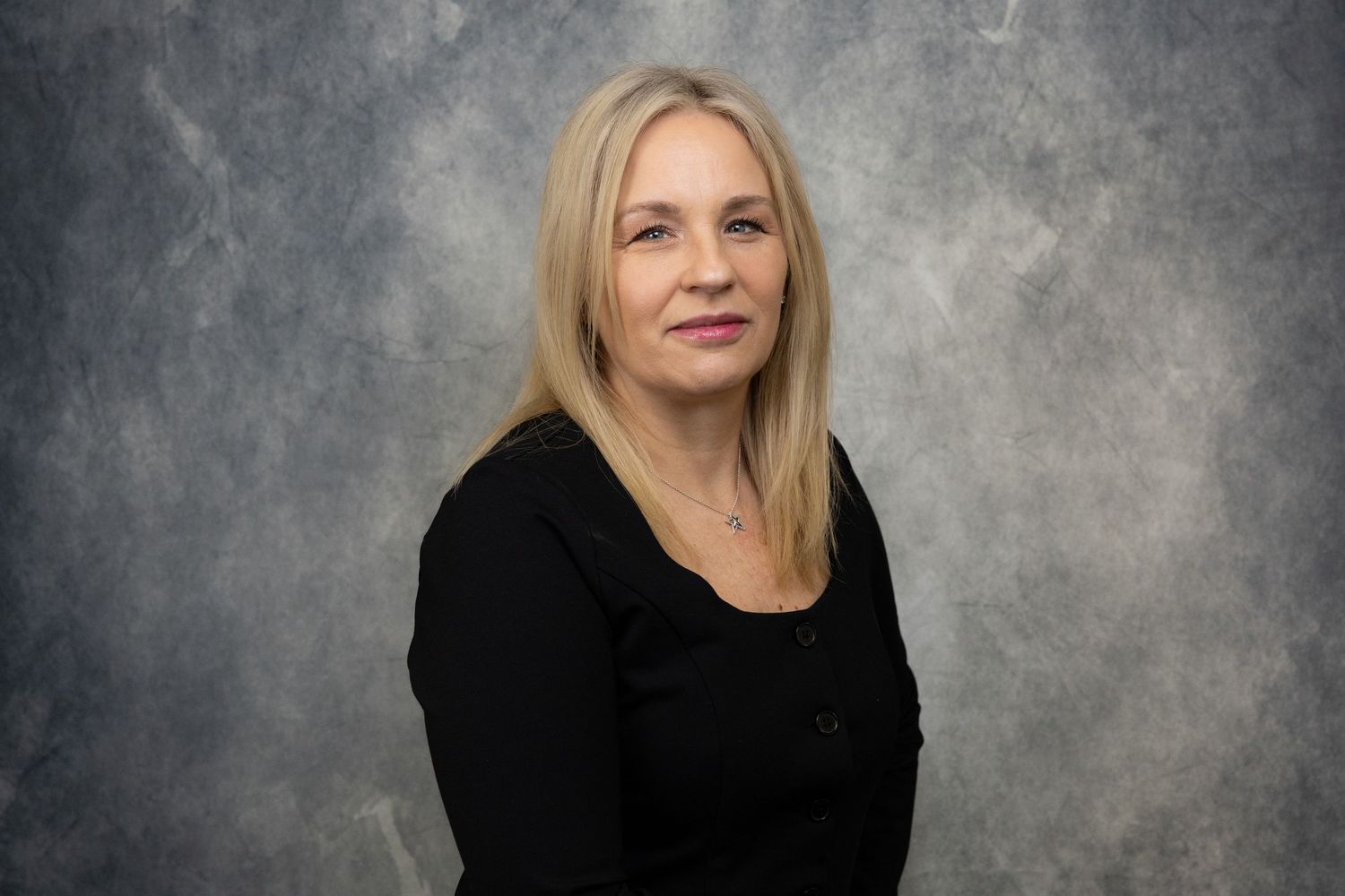 Professional headshot series showing different poses and expressions against a textured gray background.