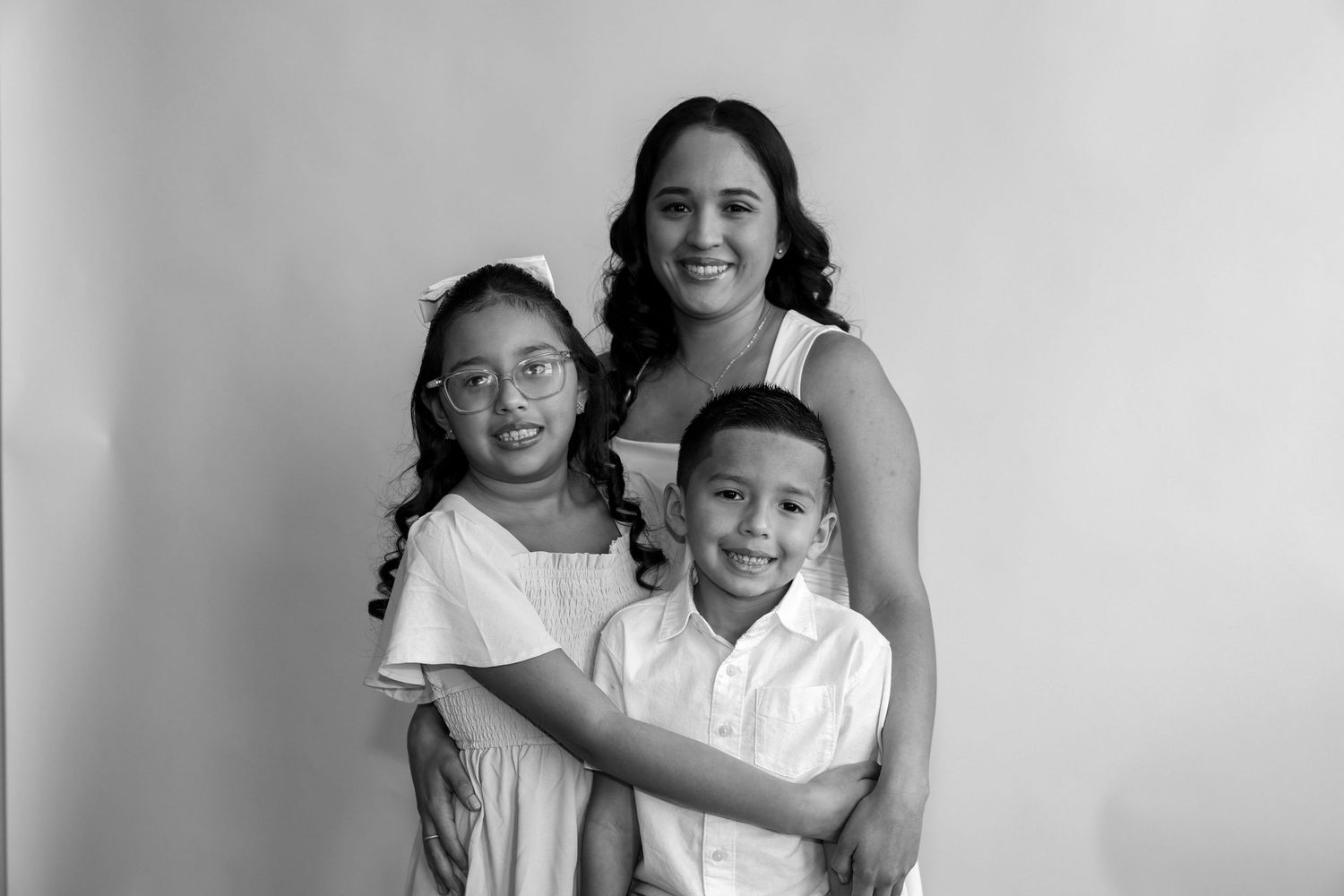 A collection of black and white family photos showing loving moments between parents and children.