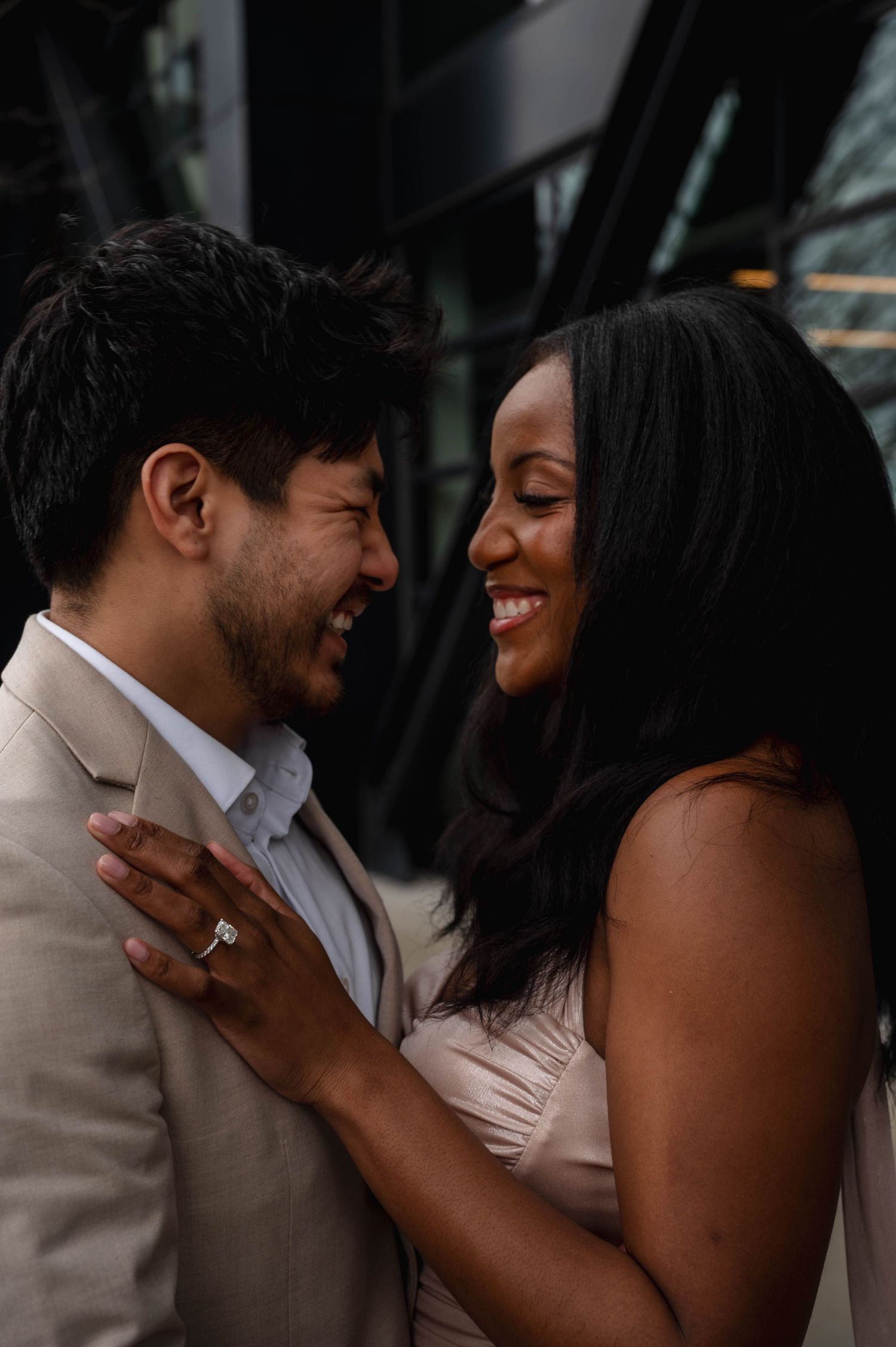 A romantic couple shares tender moments in a series of candid engagement photos.