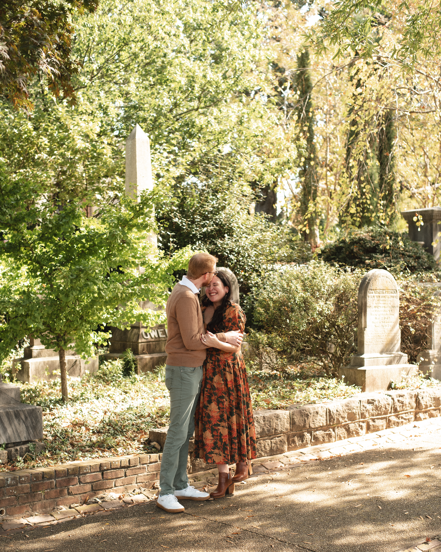 A sequence of images shows a couple embracing on a brick wall in a park-like setting with autumn foliage in the background.