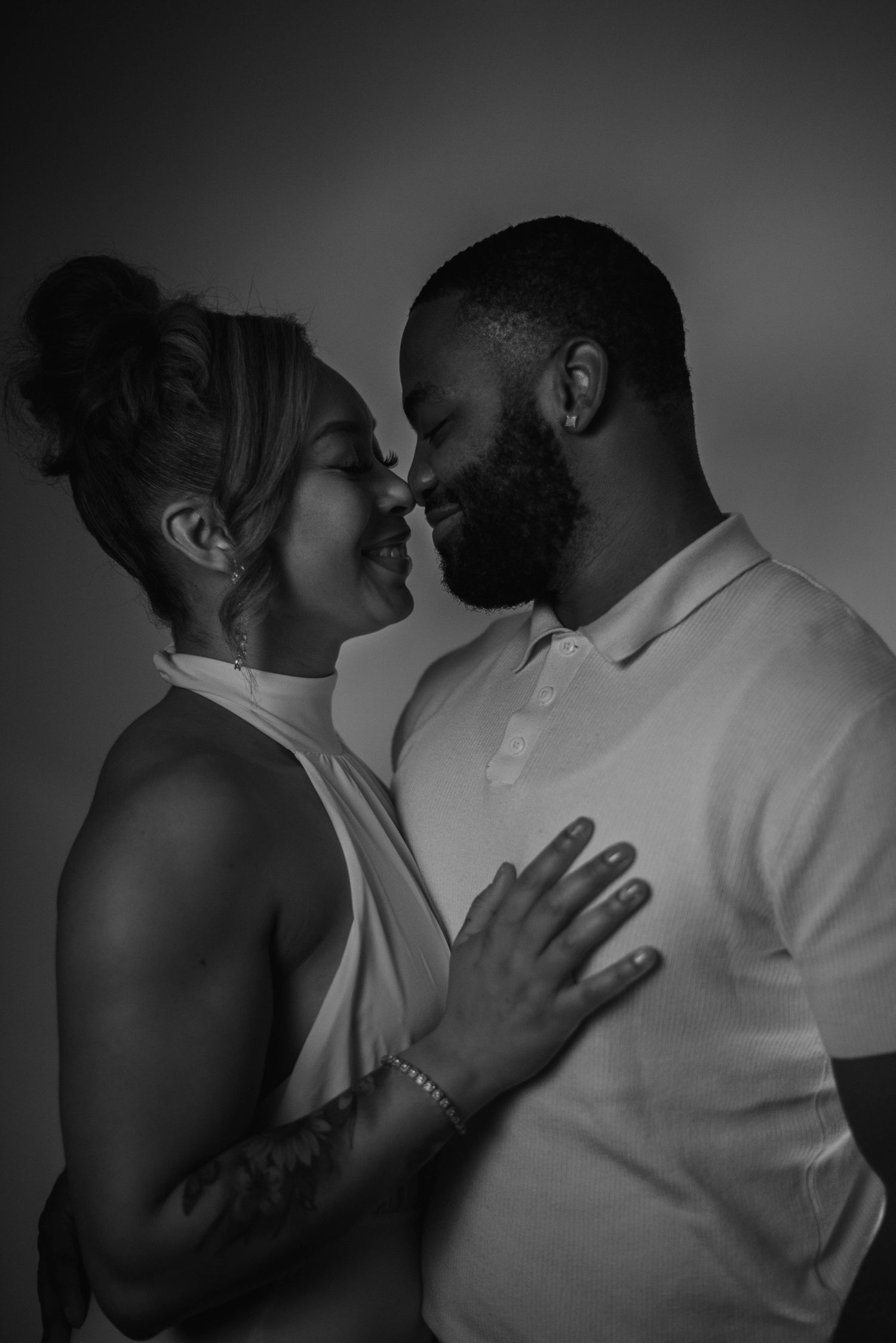 A romantic black and white photo series showing intimate moments between a couple embracing.
