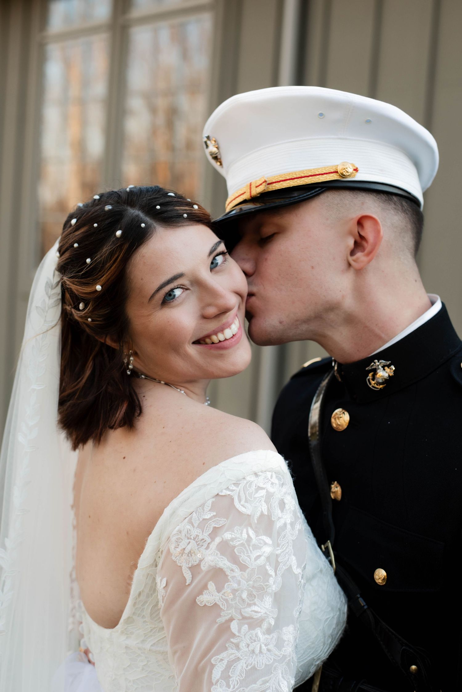 A romantic wedding sequence shows a bride and groom in military dress uniform sharing tender kisses and loving moments.