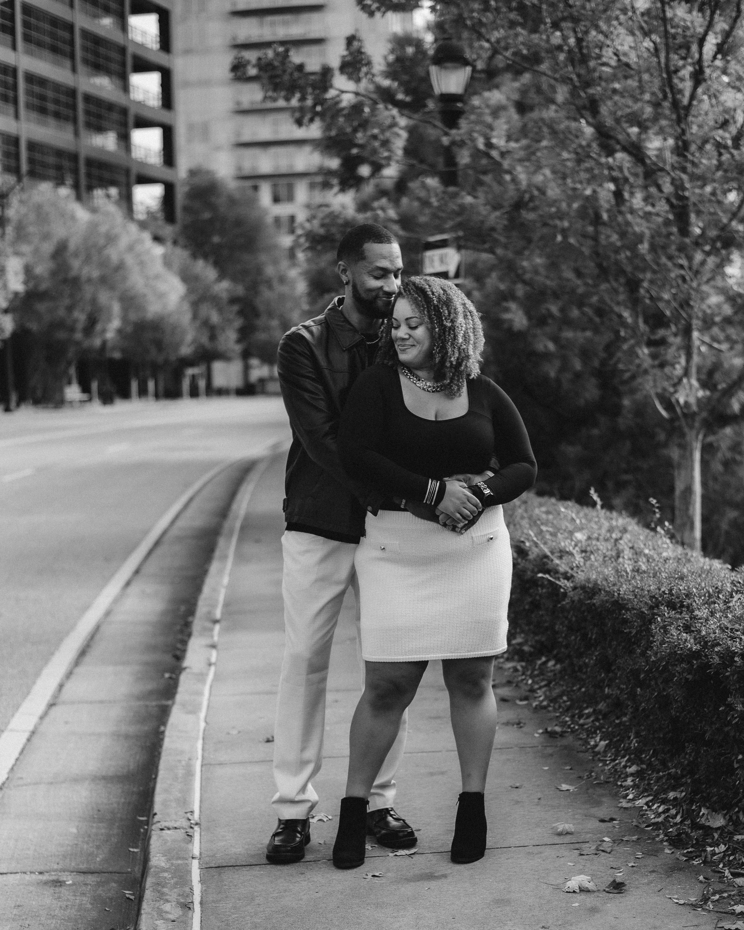 A black and white photo sequence showing legs walking along a path with trees and buildings in the background.