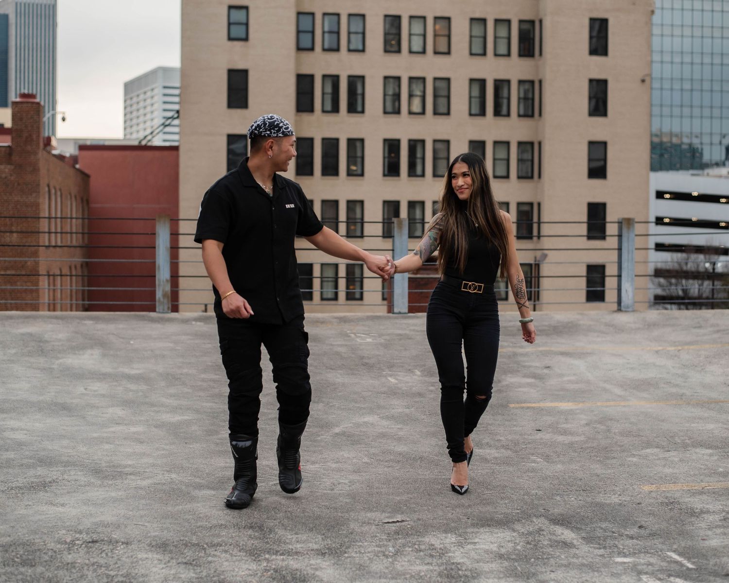 A series of photos showing two people walking together on a rooftop with urban buildings in the background.