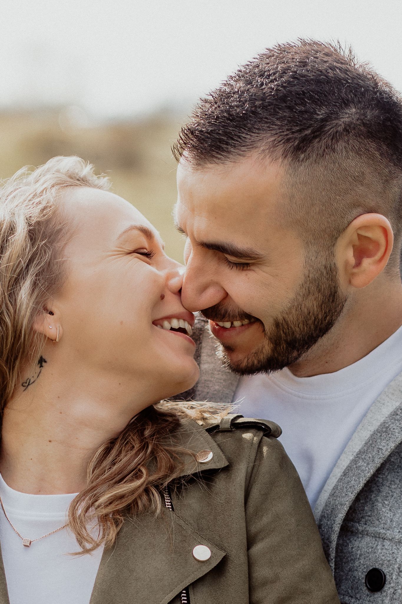 Relaxed couple portrait capturing genuine connection during a natural outdoor photoshoot