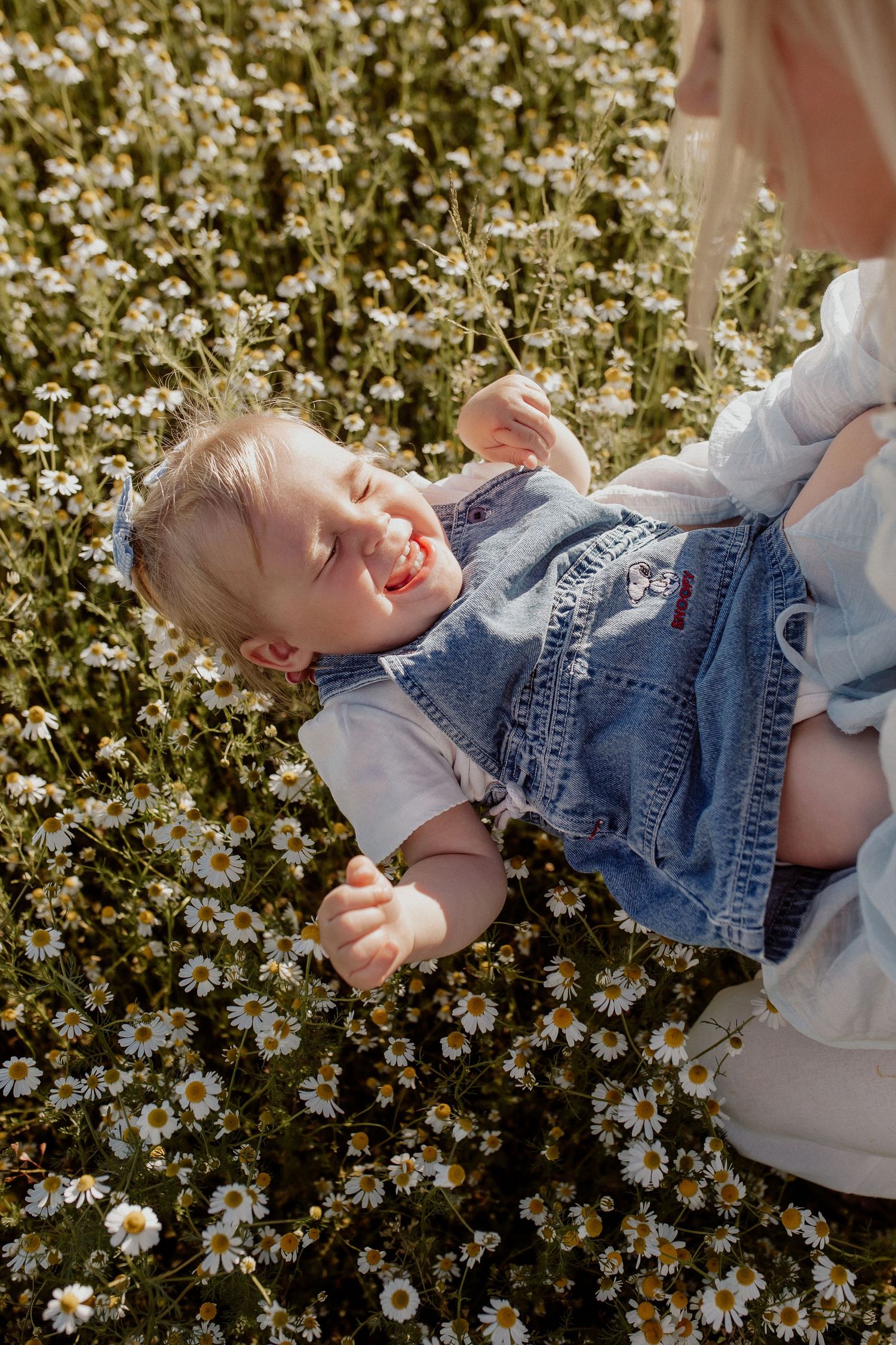 Natural family portrait of parents and children laughing together during an outdoor photography session in Latvia