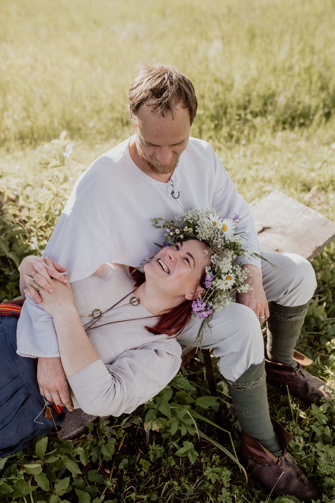 Relaxed couple portrait capturing genuine connection and laughter during a natural outdoor photoshoot