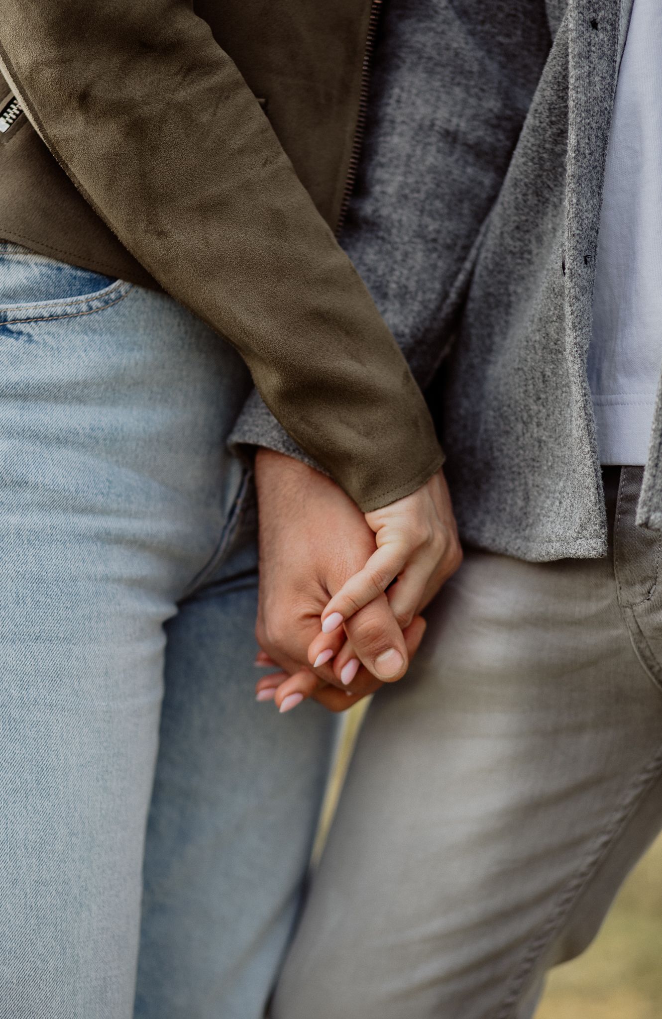 Emotional portrait showing a gentle hand touch between couple during a relaxed photography session.