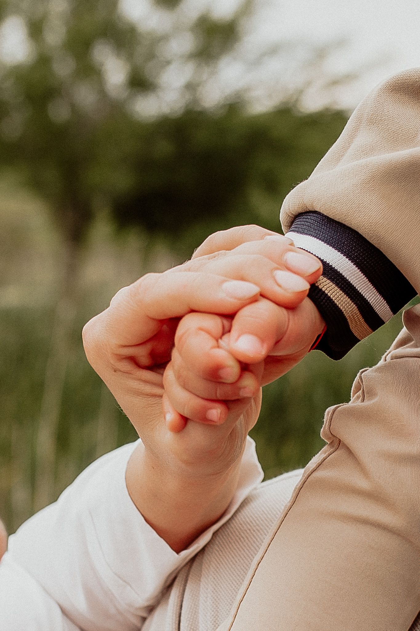 Emotional portrait showing a gentle hand touch between family members during a relaxed photography session.