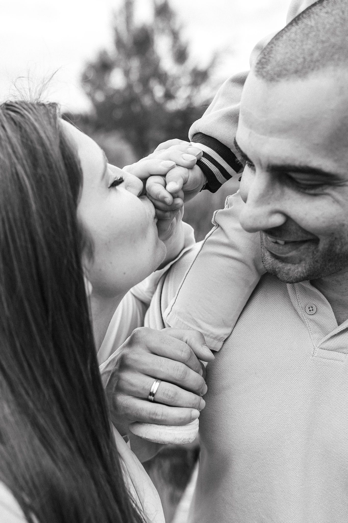 Emotional portrait showing a gentle hand touch between family members during a relaxed photography session.