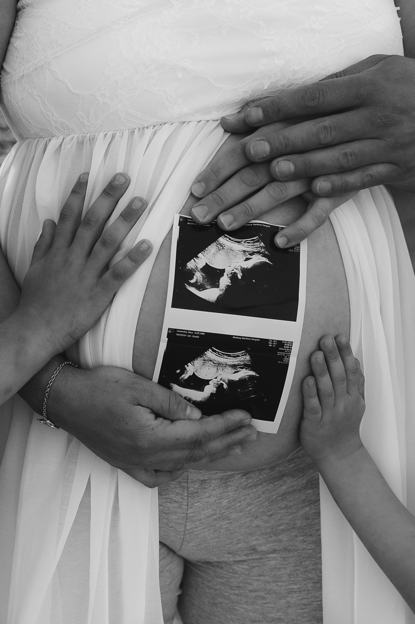 Emotional portrait showing a gentle hand touch between family members during a relaxed photography session.
