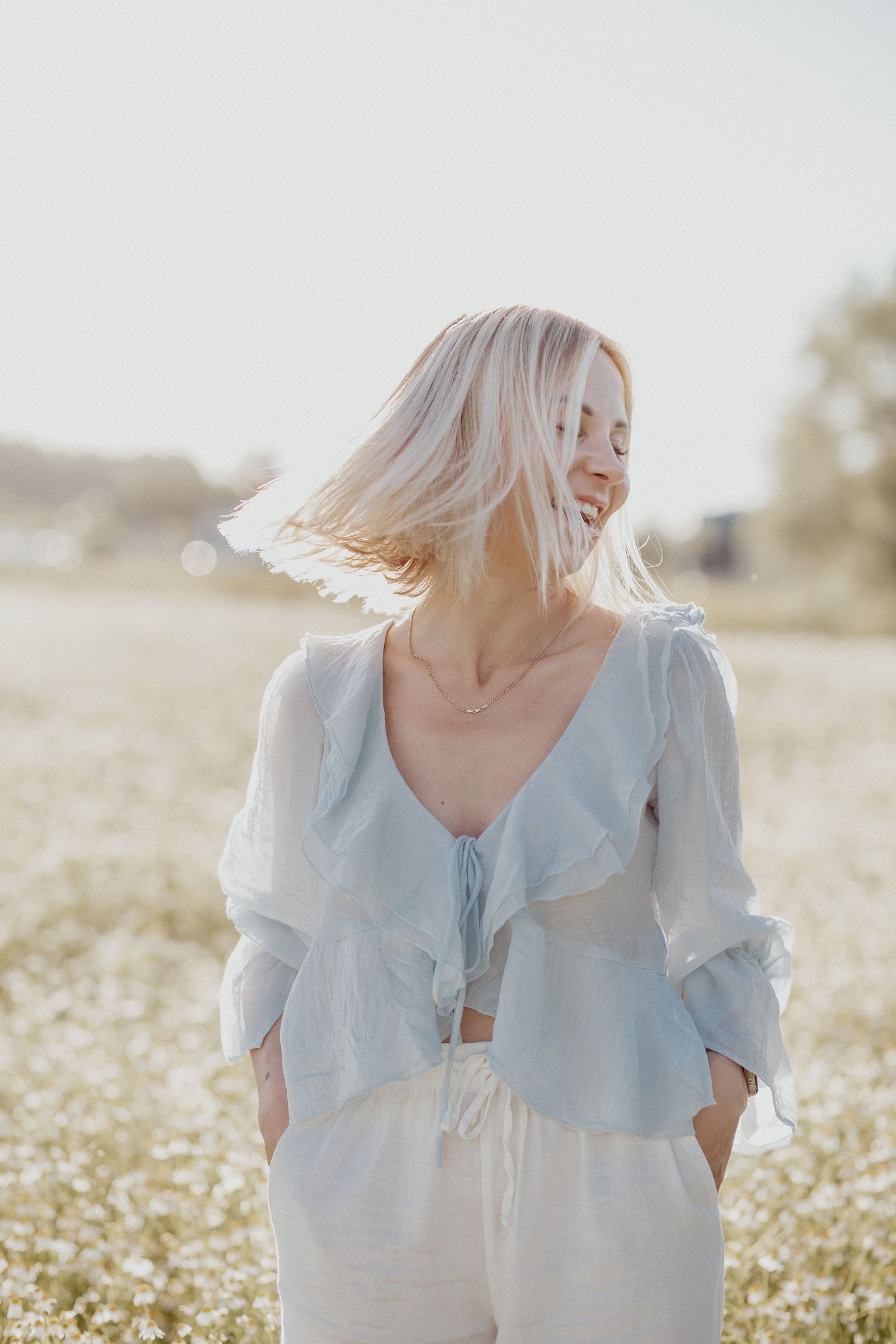 Natural lifestyle portrait of a woman in soft outdoor light, capturing authentic personality and emotion.