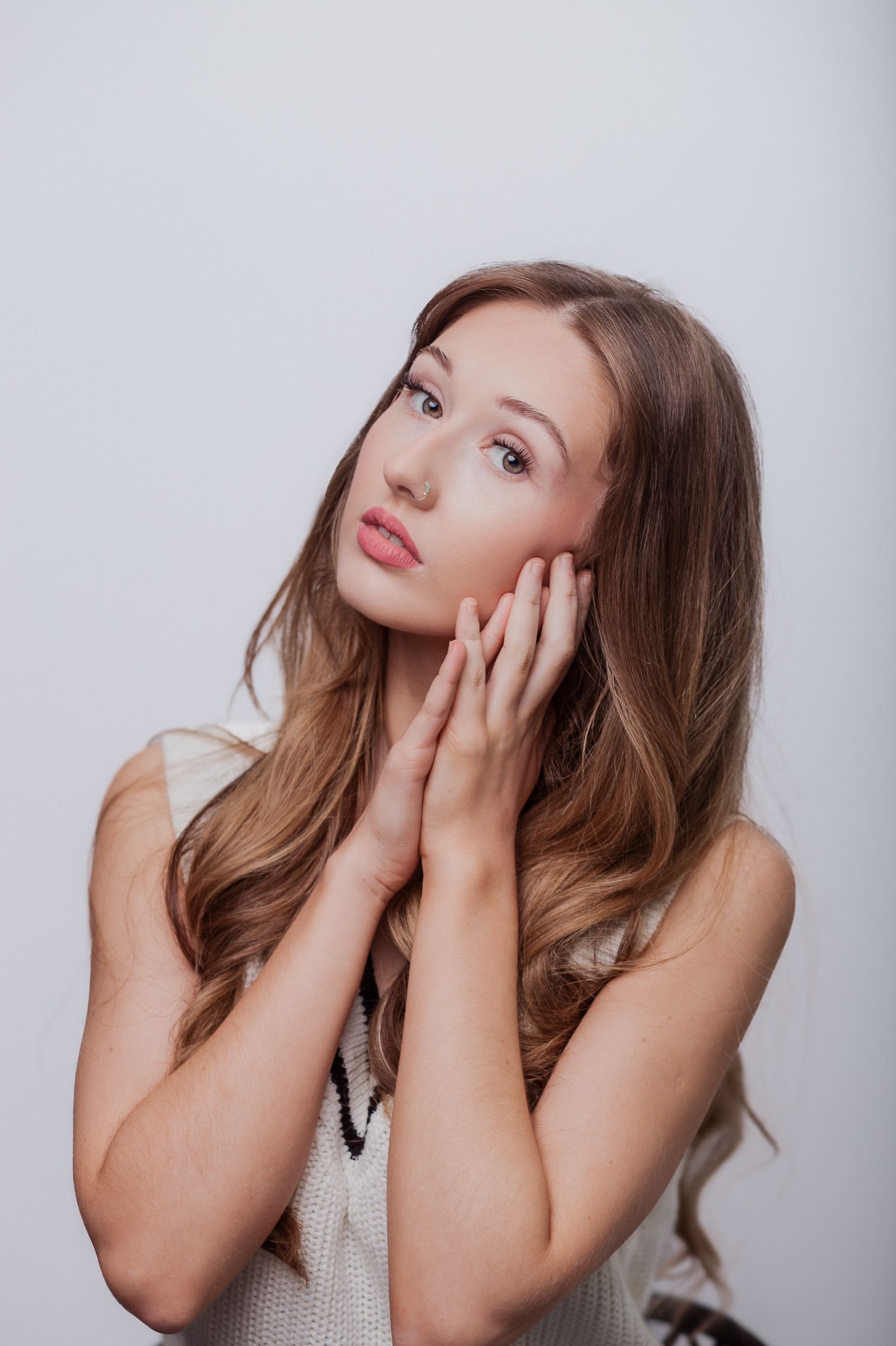Natural lifestyle portrait of a woman in soft studio light, capturing authentic personality and emotion.