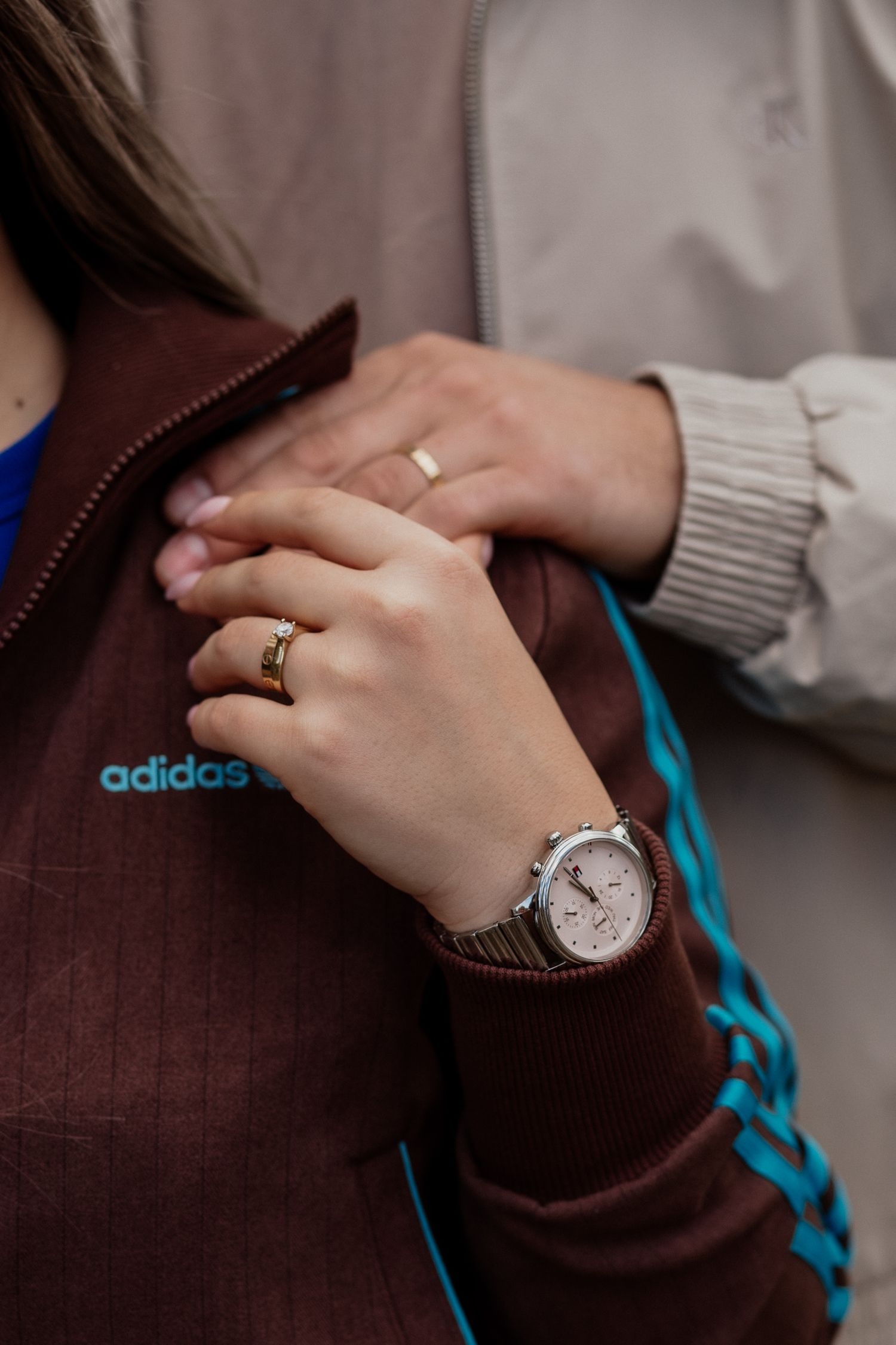 Emotional portrait showing a gentle hand touch between couple during a relaxed photography session.
