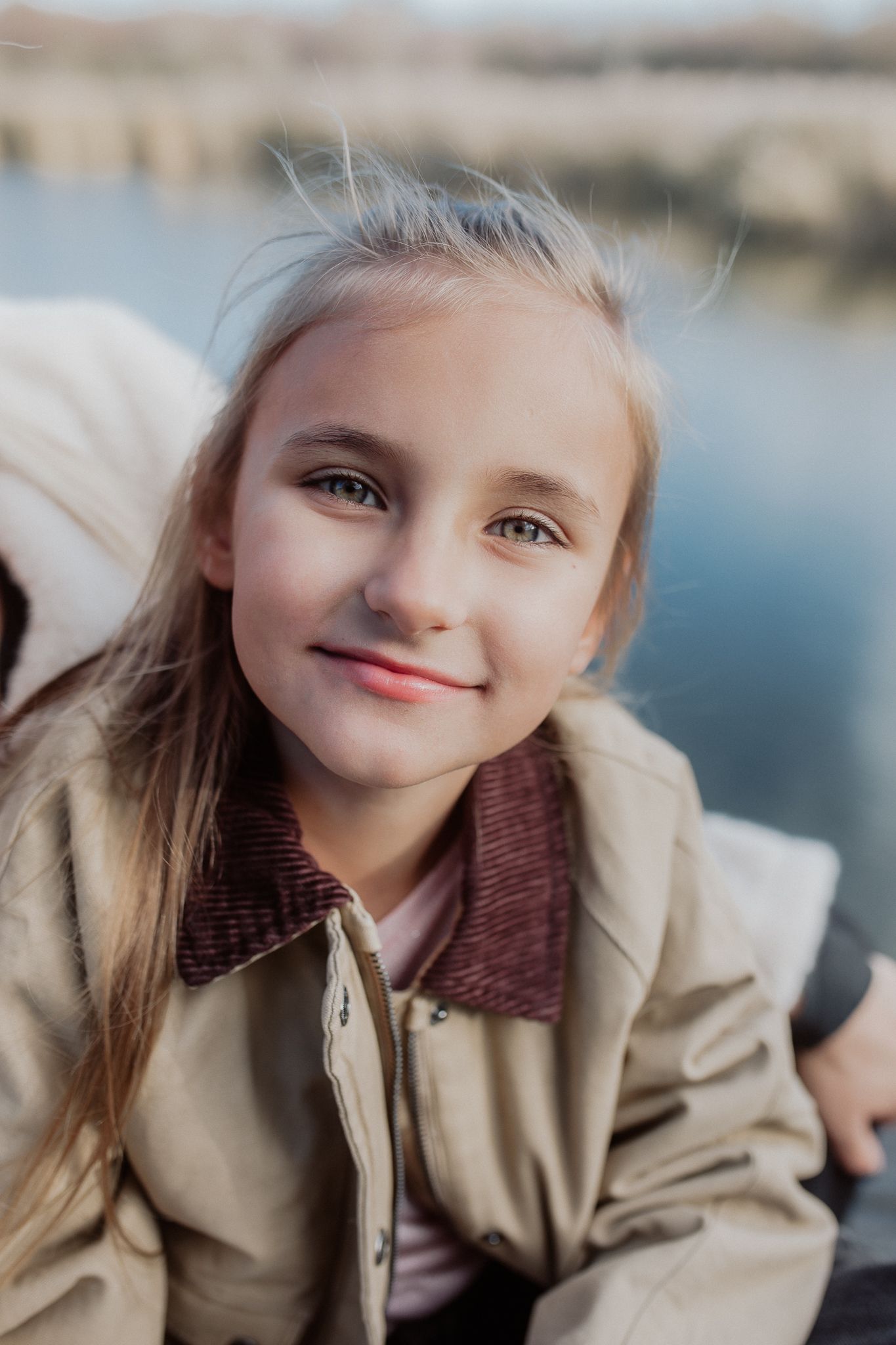 Natural close-up portrait of a child capturing a genuine smile and personality during a relaxed family photography session