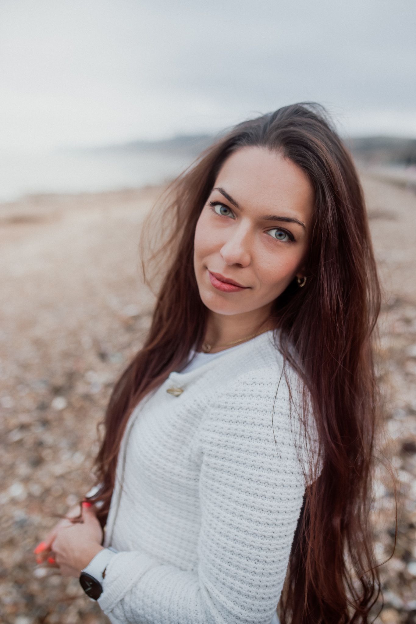 Natural lifestyle portrait of a woman in soft outdoor light, capturing authentic personality and emotion.