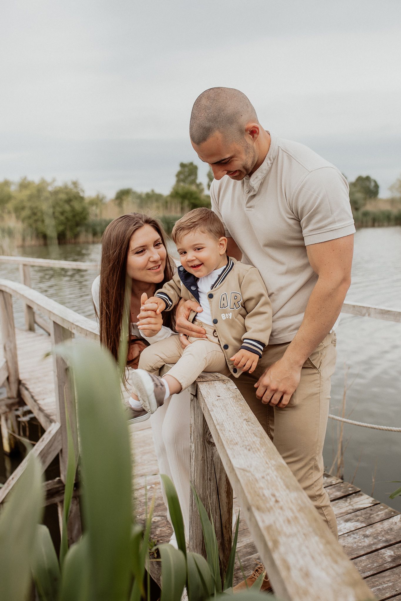 Natural family portrait of parents and children laughing together during an outdoor photography session in Kent.