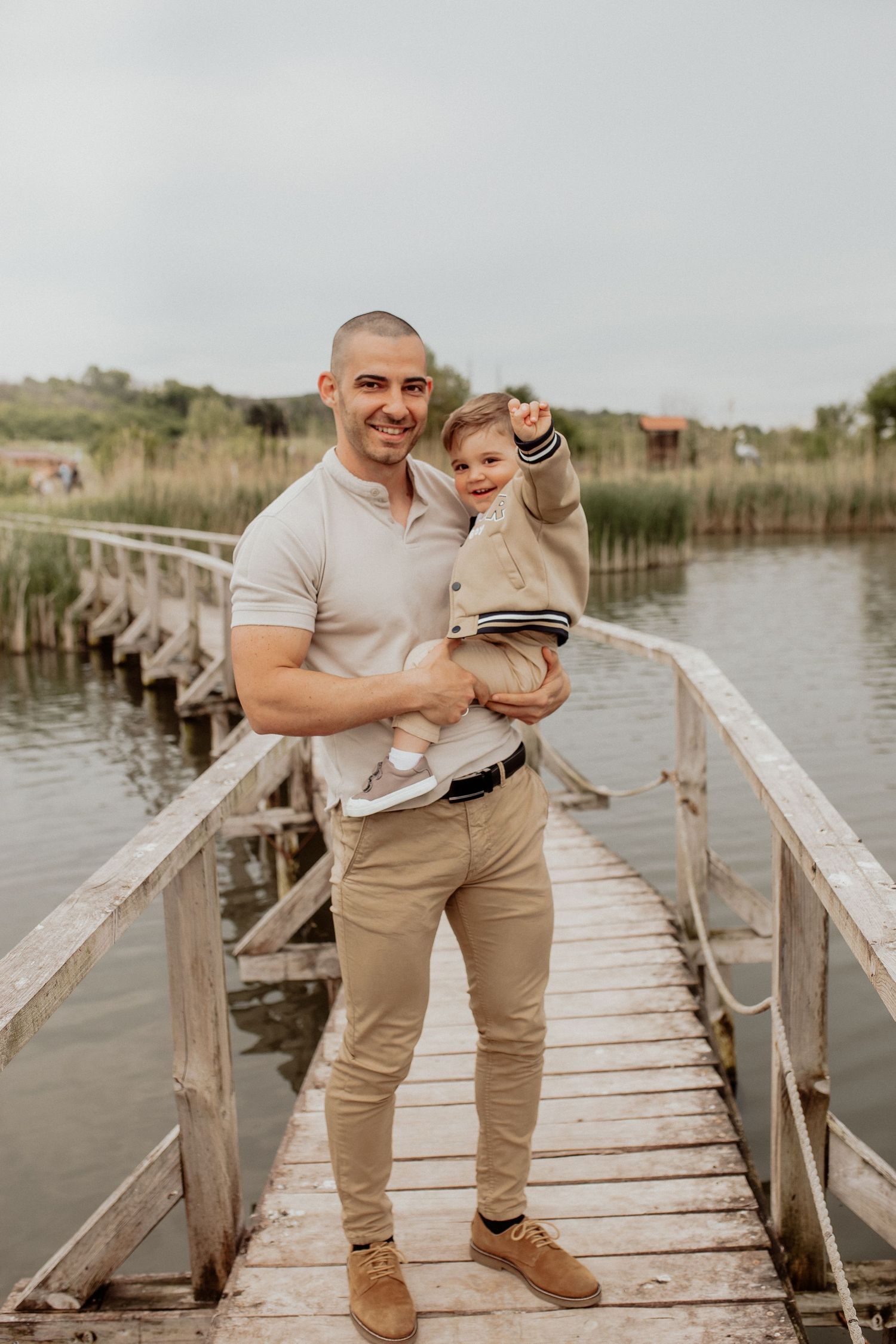 Natural family portrait of parents and children laughing together during an outdoor photography session in Bulgaria