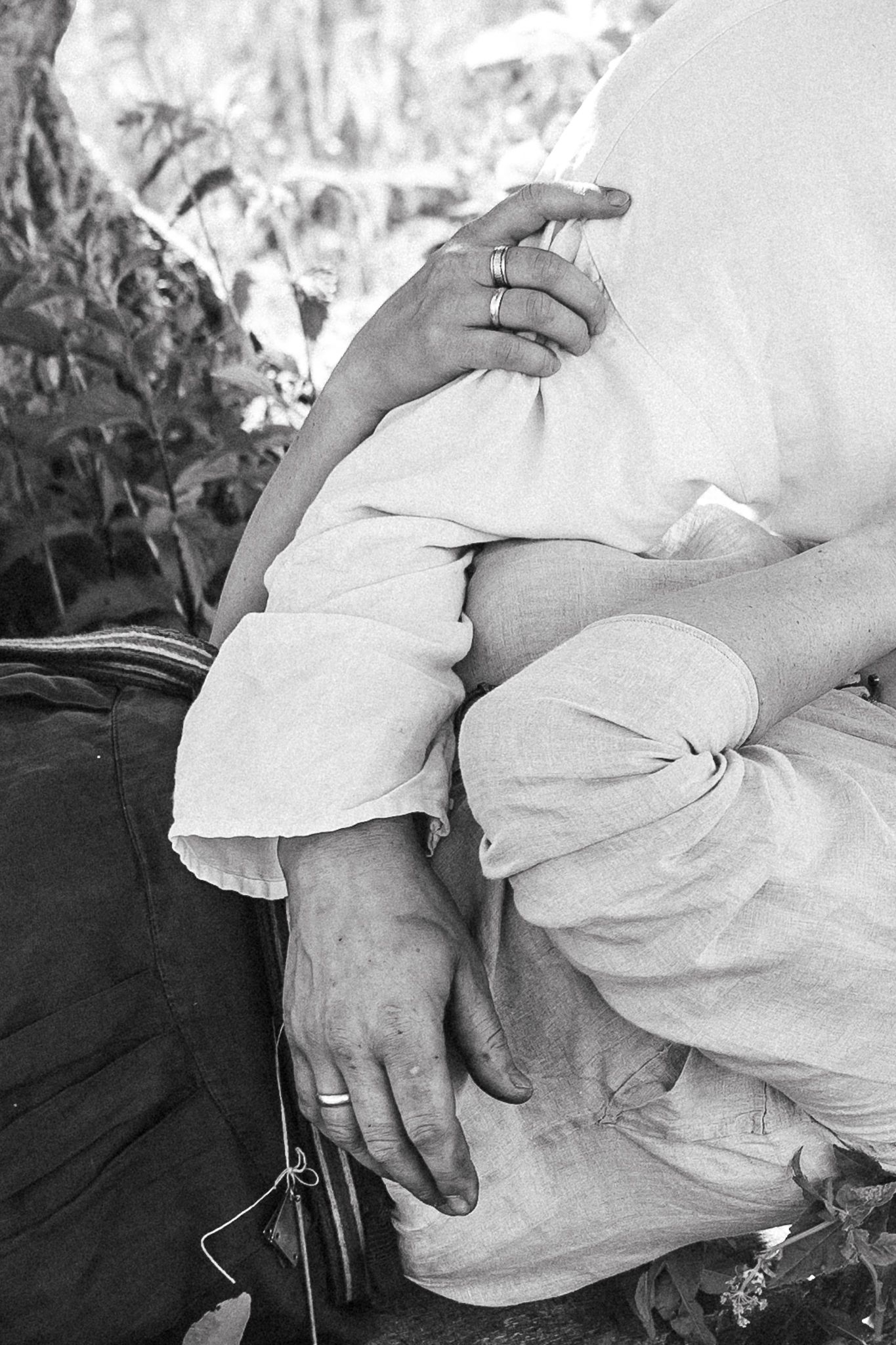 Emotional portrait showing a gentle hand touch between couple during a relaxed photography session.