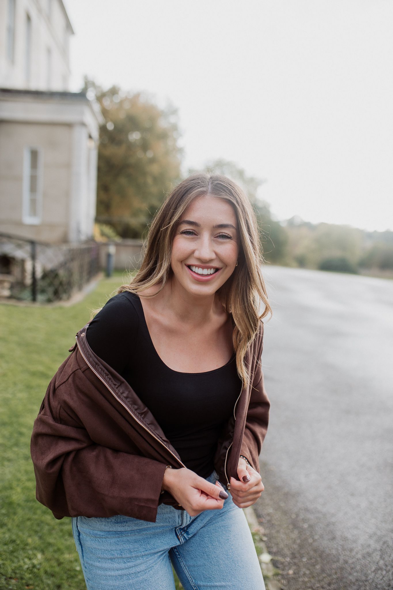 Natural lifestyle portrait of a woman in soft outdoor light, capturing authentic personality and emotion.