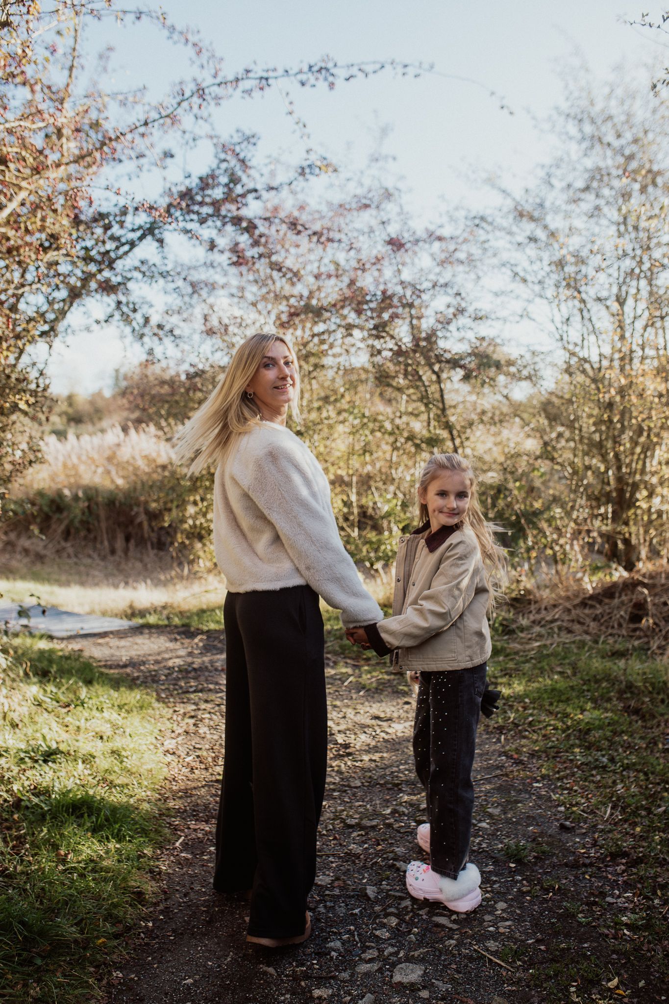 Natural family portrait of parents and children laughing together during an outdoor photography session in Kent.