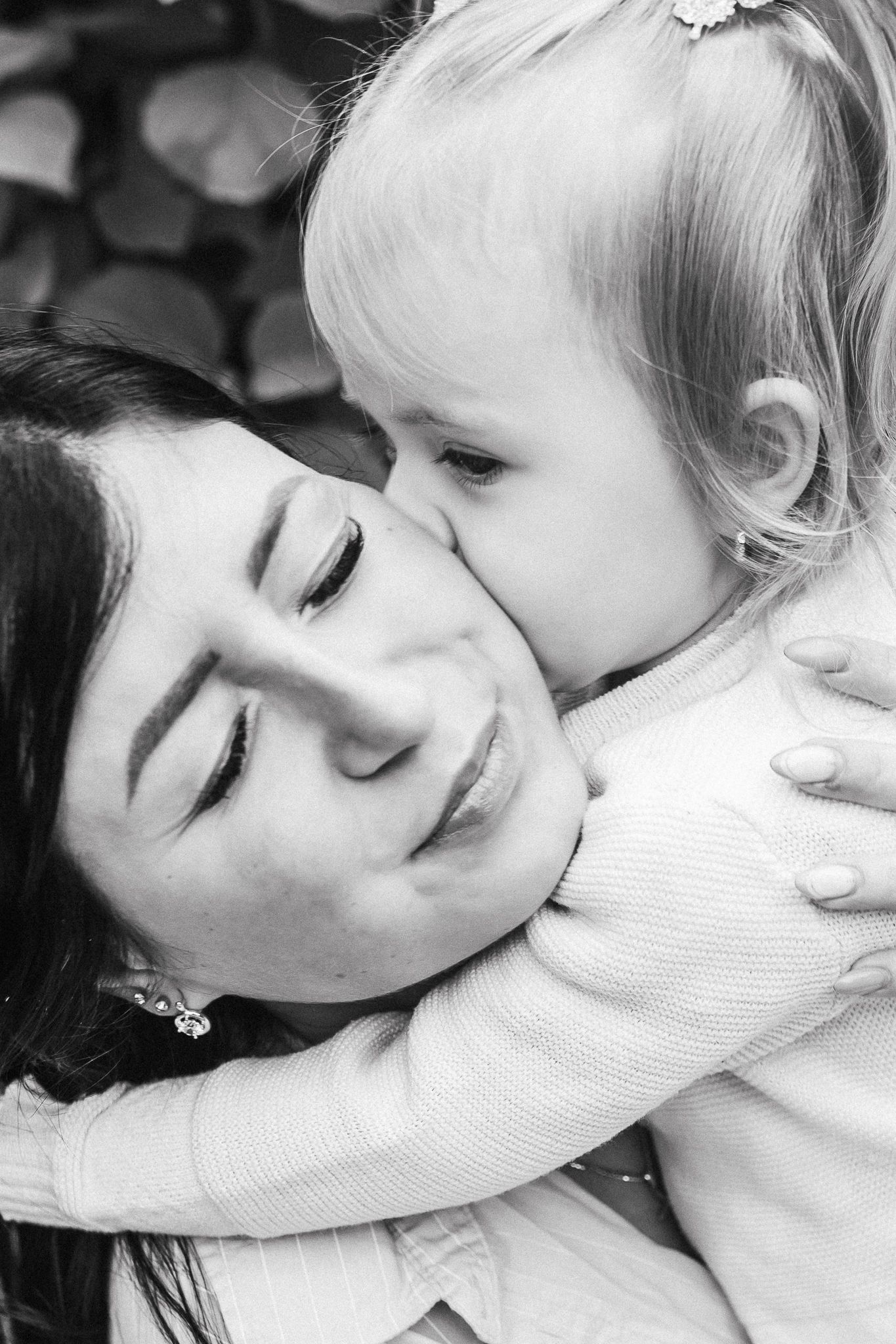 Beautiful family close up photo of mother and daughter hugging
