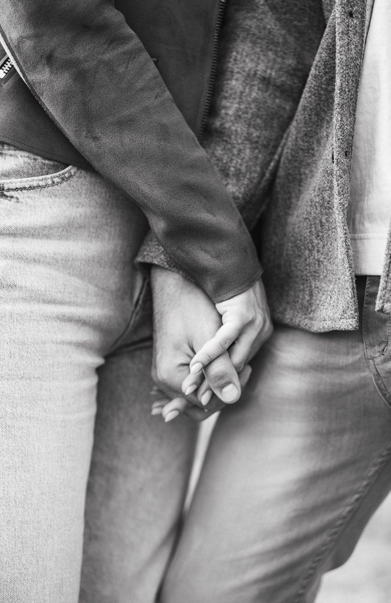 Emotional portrait showing a gentle hand touch between family members during a relaxed photography session.
