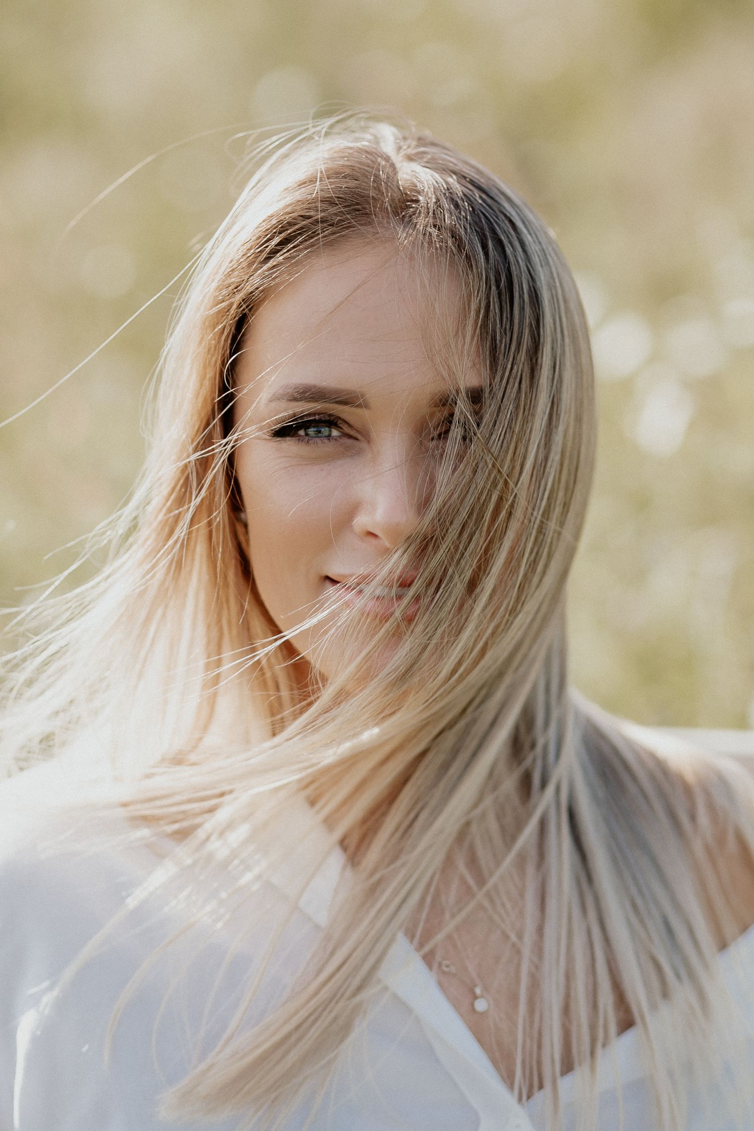 Natural lifestyle portrait of a woman in soft outdoor light, capturing authentic personality and emotion.