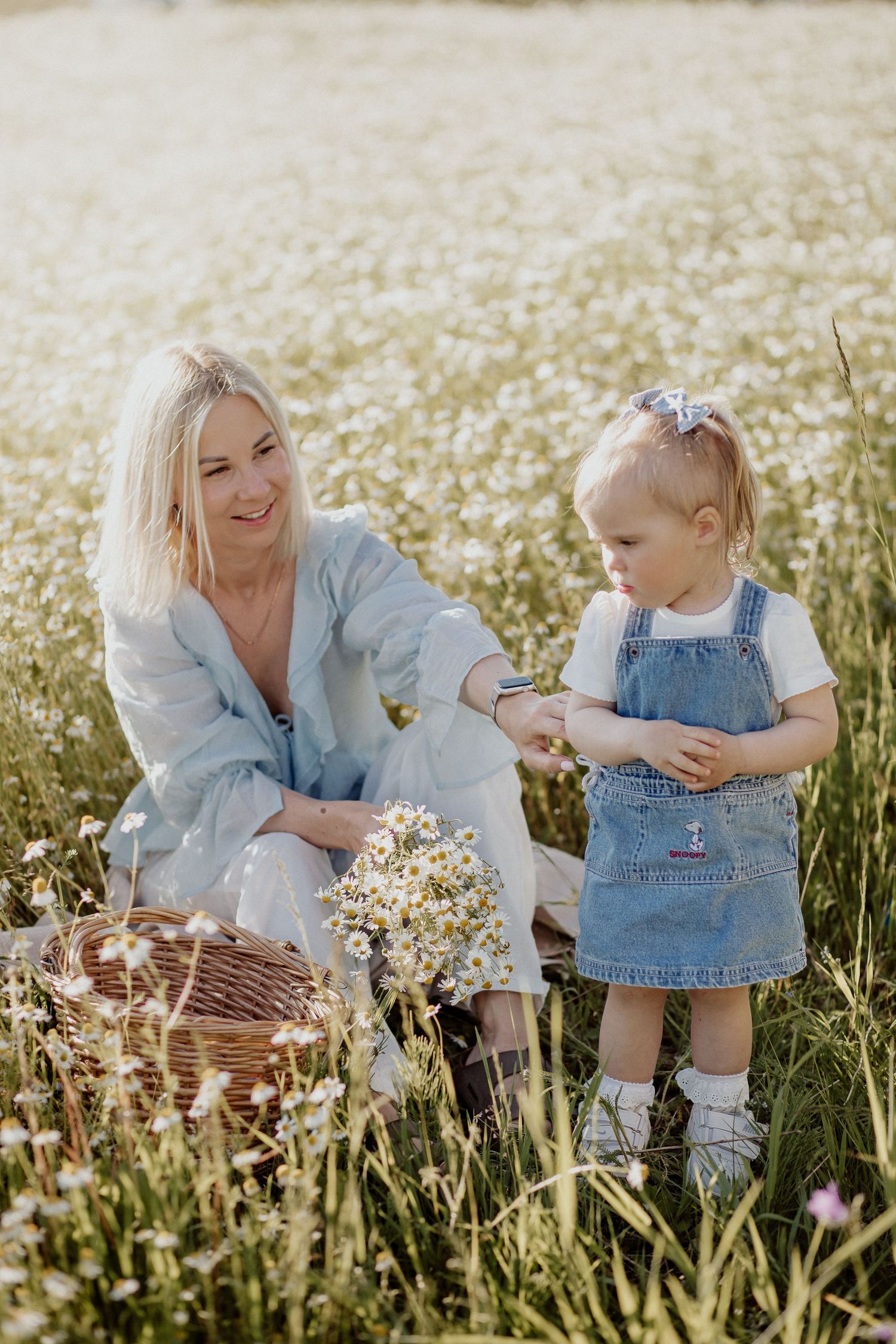 Mother and daughter in flower field