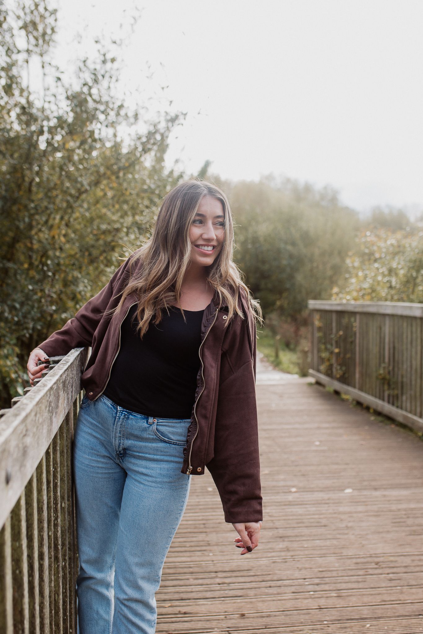 Natural lifestyle portrait of a woman in soft outdoor light, capturing authentic personality and emotion.