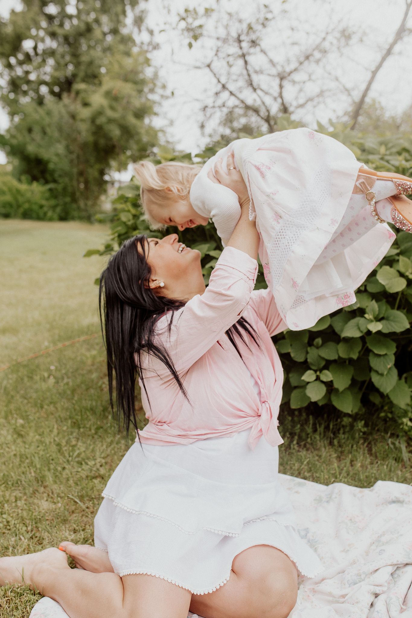 Natural family portrait of parents and children laughing together during an outdoor photography session in Latvia