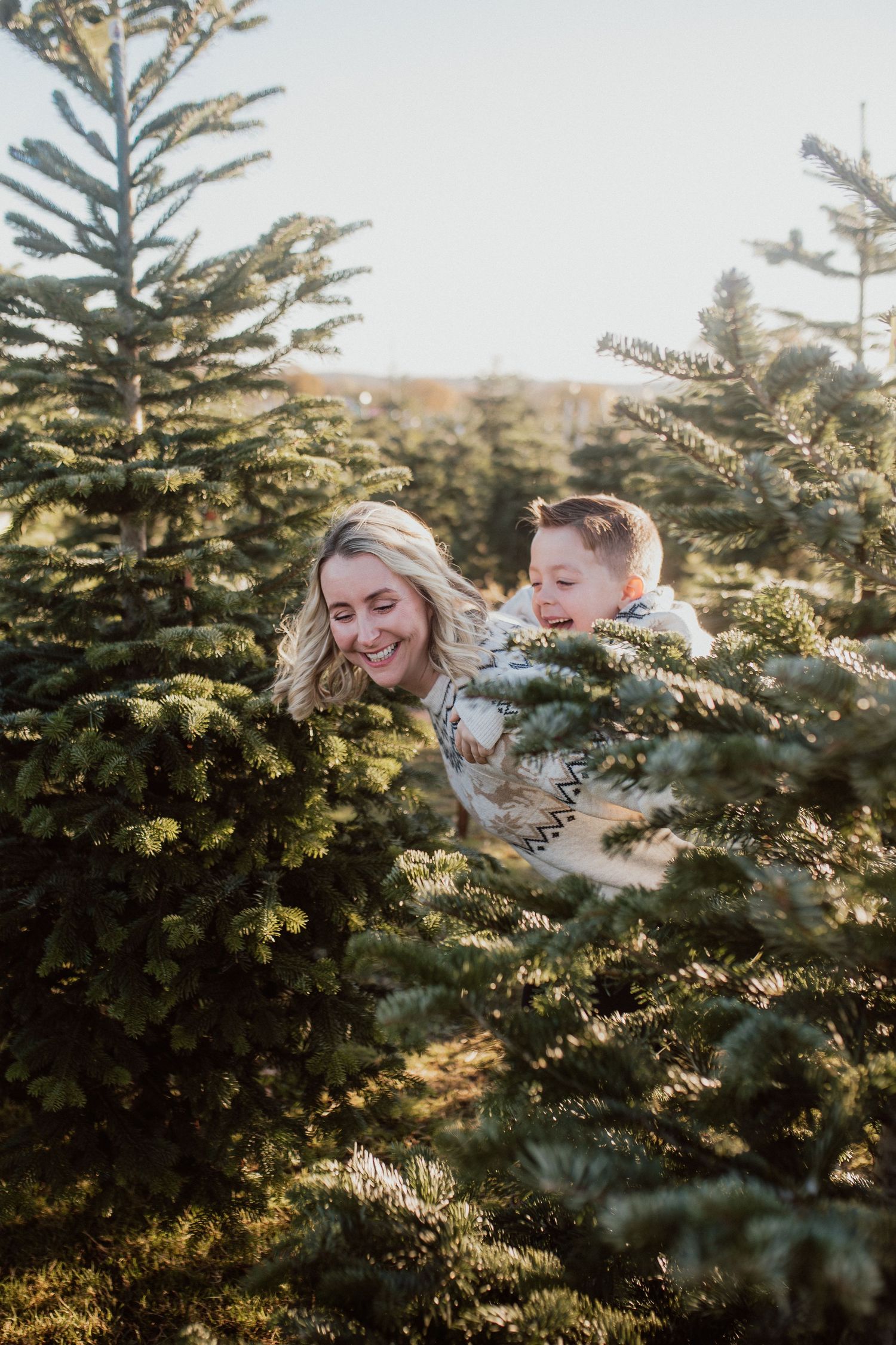 Natural family portrait of parents and children laughing together during an outdoor photography session in Kent.
