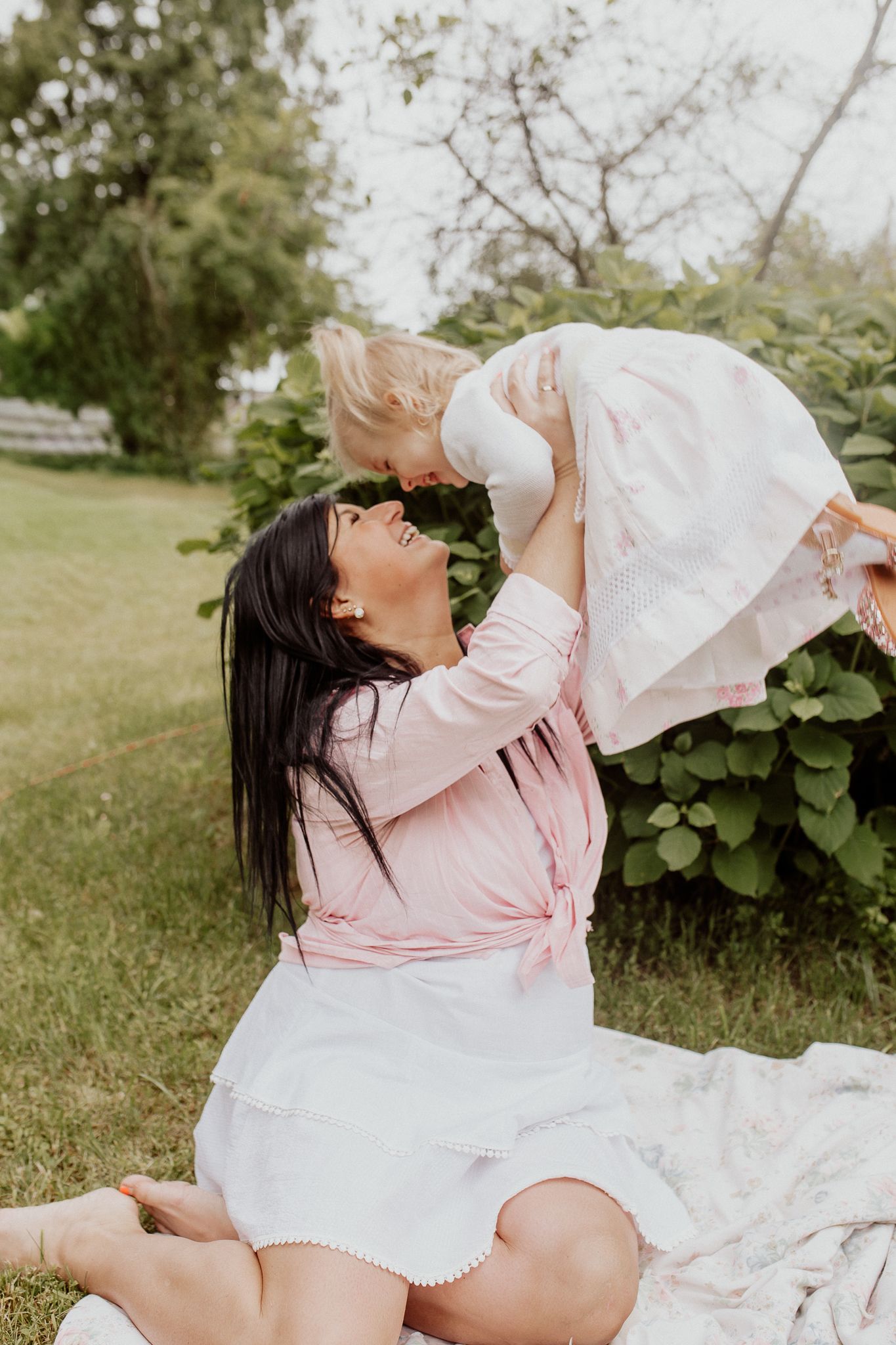 Natural family portrait of parents and children laughing together during an outdoor photography session in Kent.
