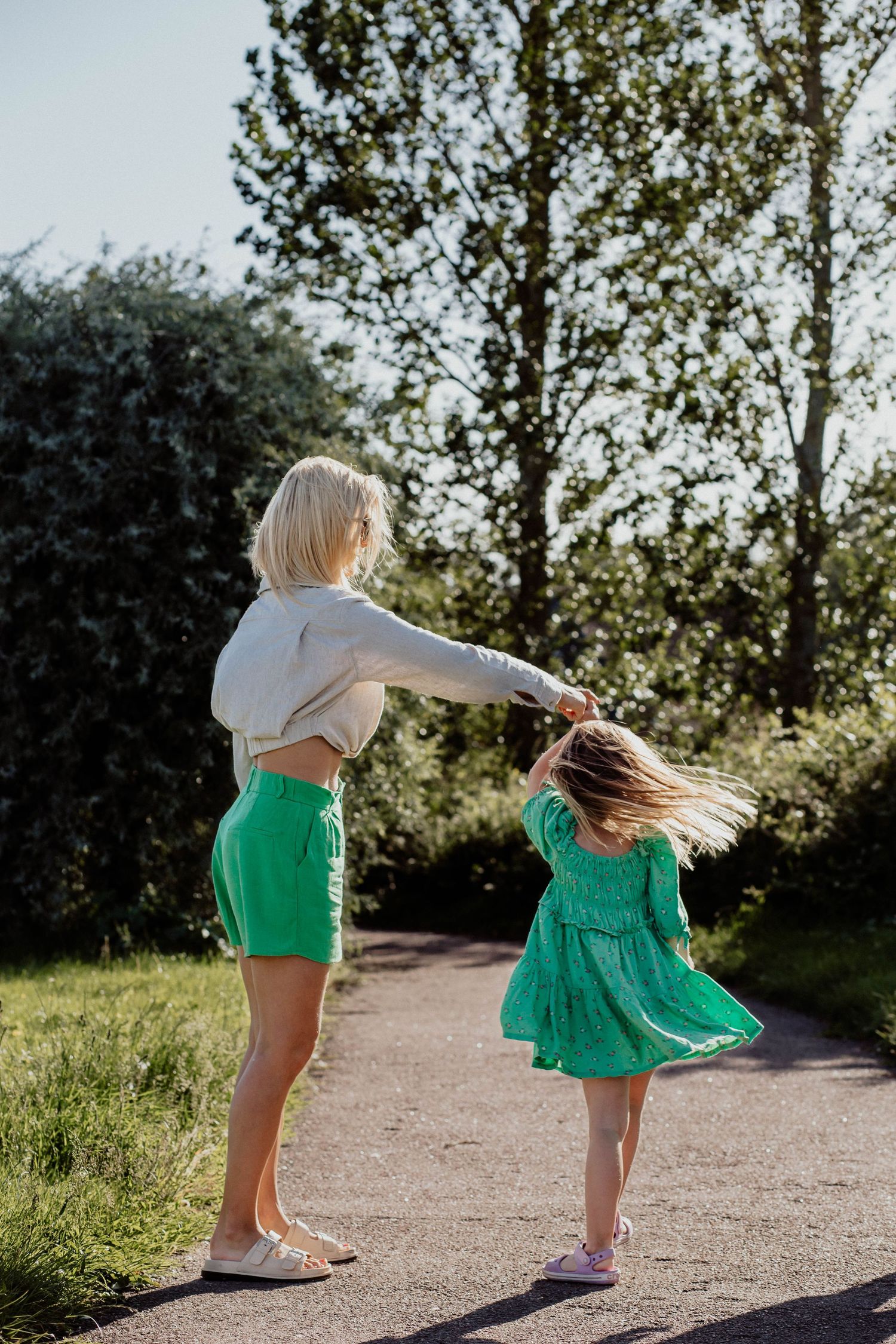 Portrait of mother and daughter dancing capturing movement