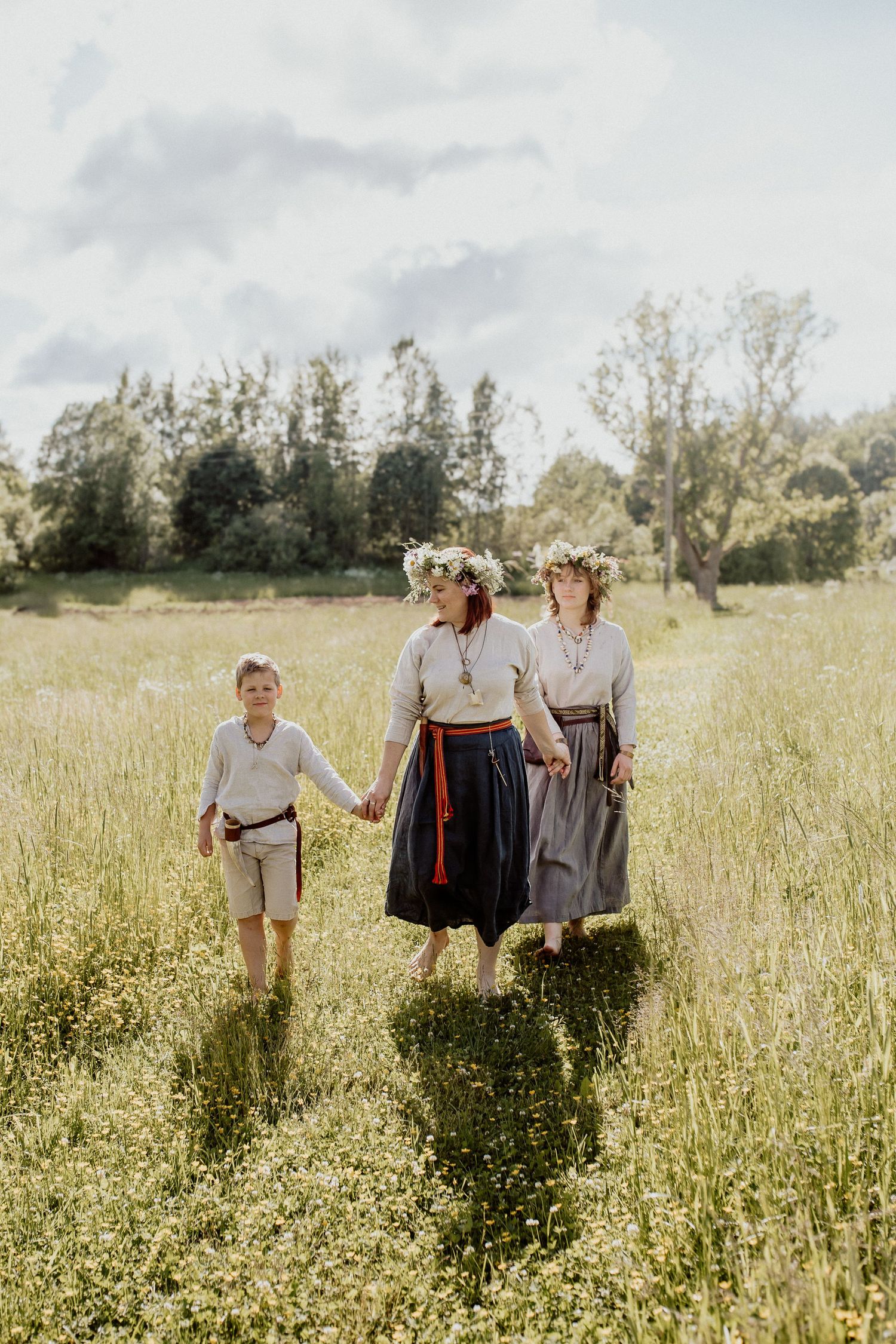 Natural family portrait of parents and children laughing together during an outdoor photography session in Latvia