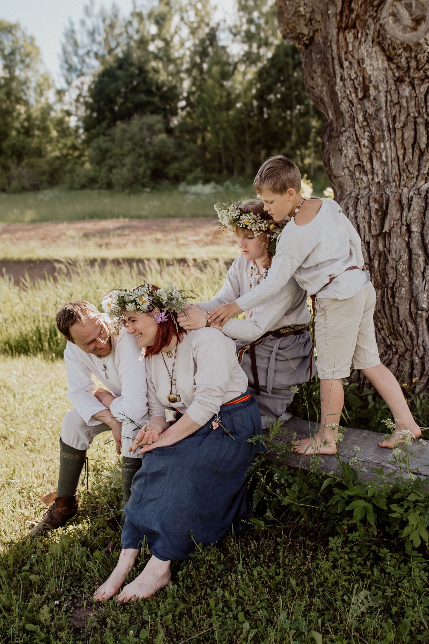 Natural family portrait of parents and children laughing together during an outdoor photography session in Latvia