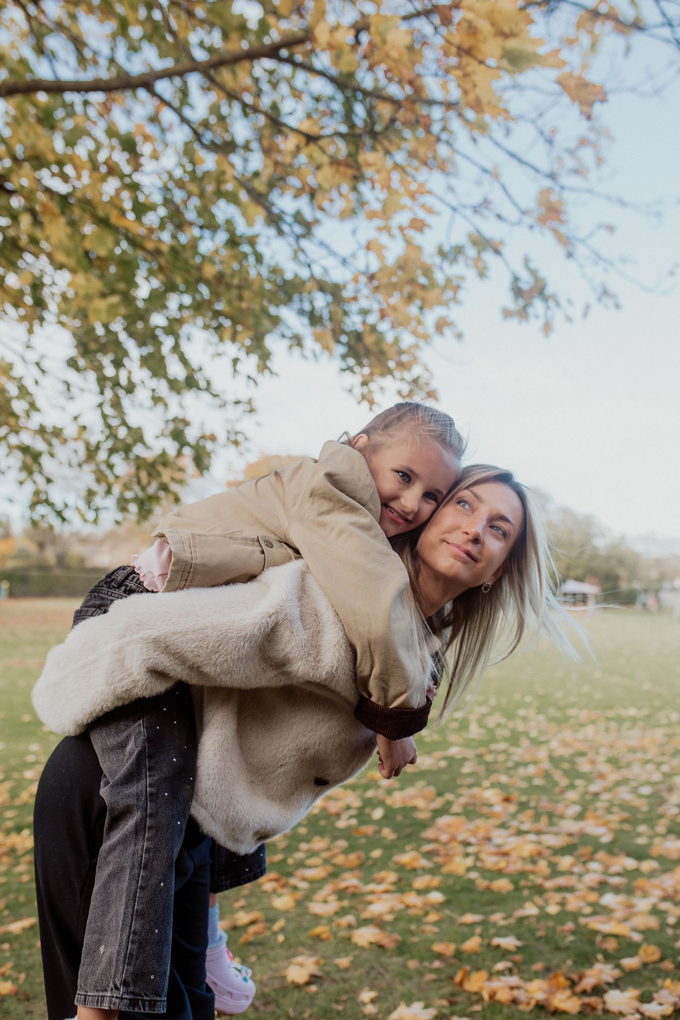 Natural family portrait of parents and children laughing together during an outdoor photography session in Kent.